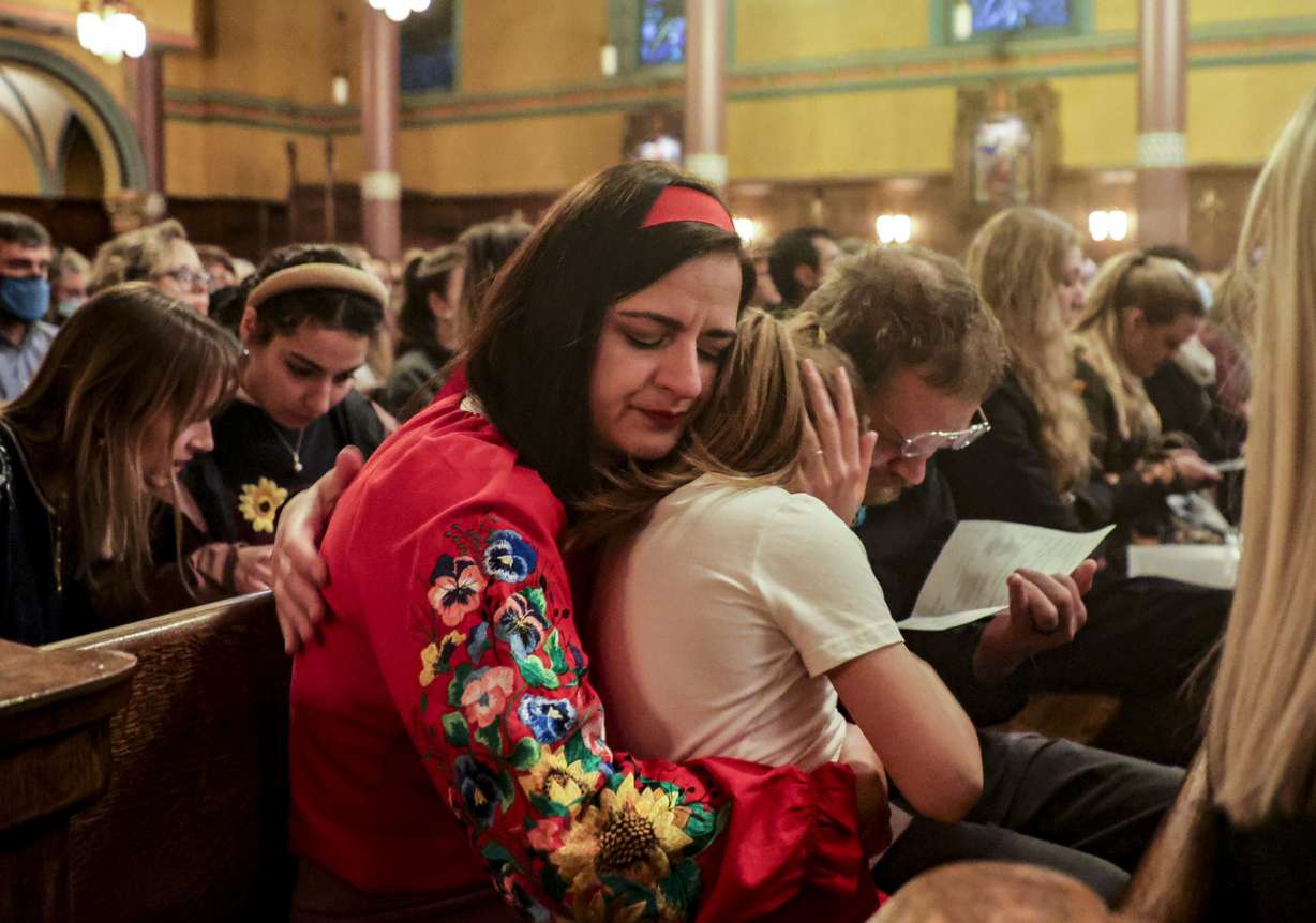Kateryna Hansen, a Utah Ukrainian resident, hugs her daughter, Zoriana, after giving a speech at the Voices for Ukraine event at the Cathedral of the Madeleine in Salt Lake City on Monday.