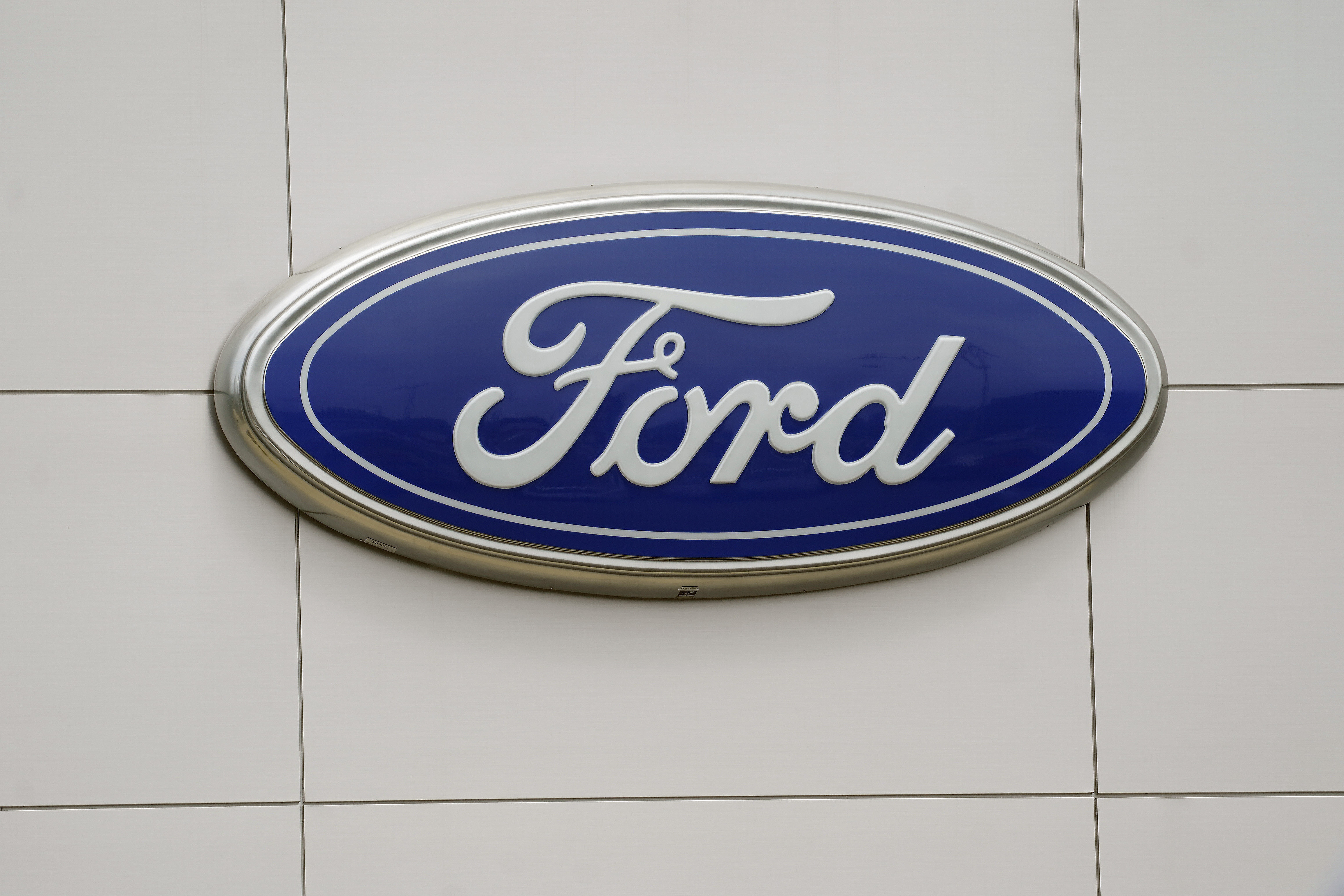 Ford is recalling nearly 215,000 pickup trucks and large SUVs in the U.S. and Canada Tuesday because brake fluid can leak and cause longer stopping distances.   