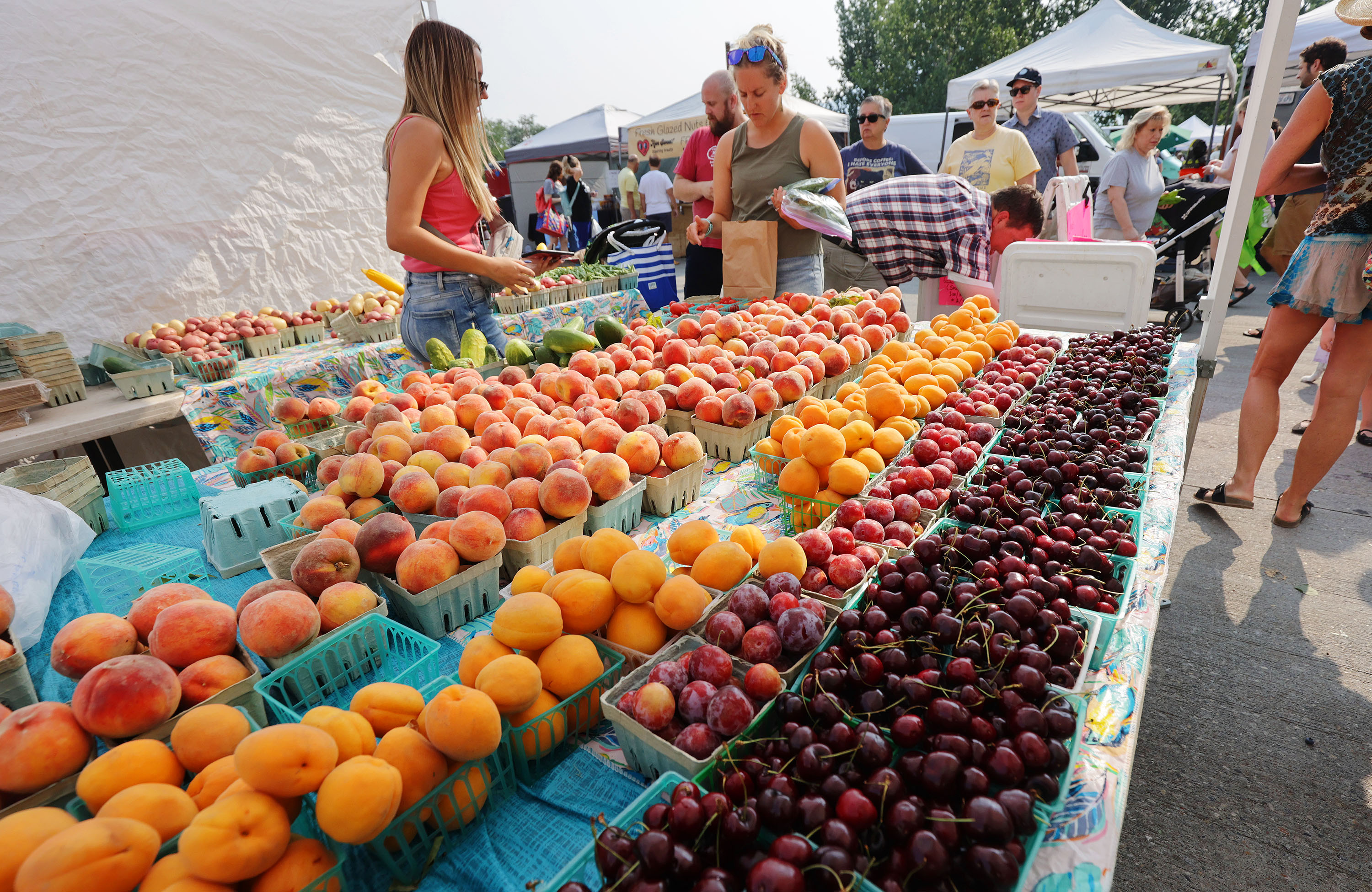 Chad’s Produce sells fruit at the Wheeler Historic Farm farmers market in Murray on July 25, 2021. The food and agriculture industries had an economic impact of over $70 billion in 2021, according to a report released Tuesday.