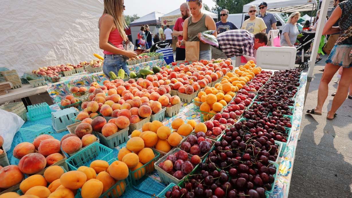 Chad’s Produce sells fruit at the Wheeler Historic Farm farmers market in Murray on July 25, 2021. The food and agriculture industries had an economic impact of over $70 billion in 2021, according to a report released Tuesday.