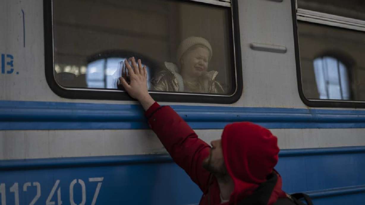 Displaced Ukrainians on a Poland-bound train bid farewell in Lviv, western Ukraine, Tuesday. The U.N. refugee agency says more than 3.5 million people have fled Ukraine since Russia's invasion, passing another milestone in an exodus that has led to Europe's worst refugee crisis since World War II.