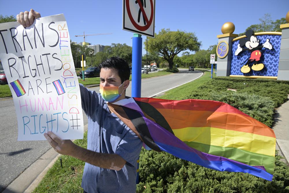 Disney cast member Nicholas Maldonado protests his company's stance on LGBTQ issues, while participating in an employee walkout at Walt Disney World, Tuesday in Lake Buena Vista, Fla.