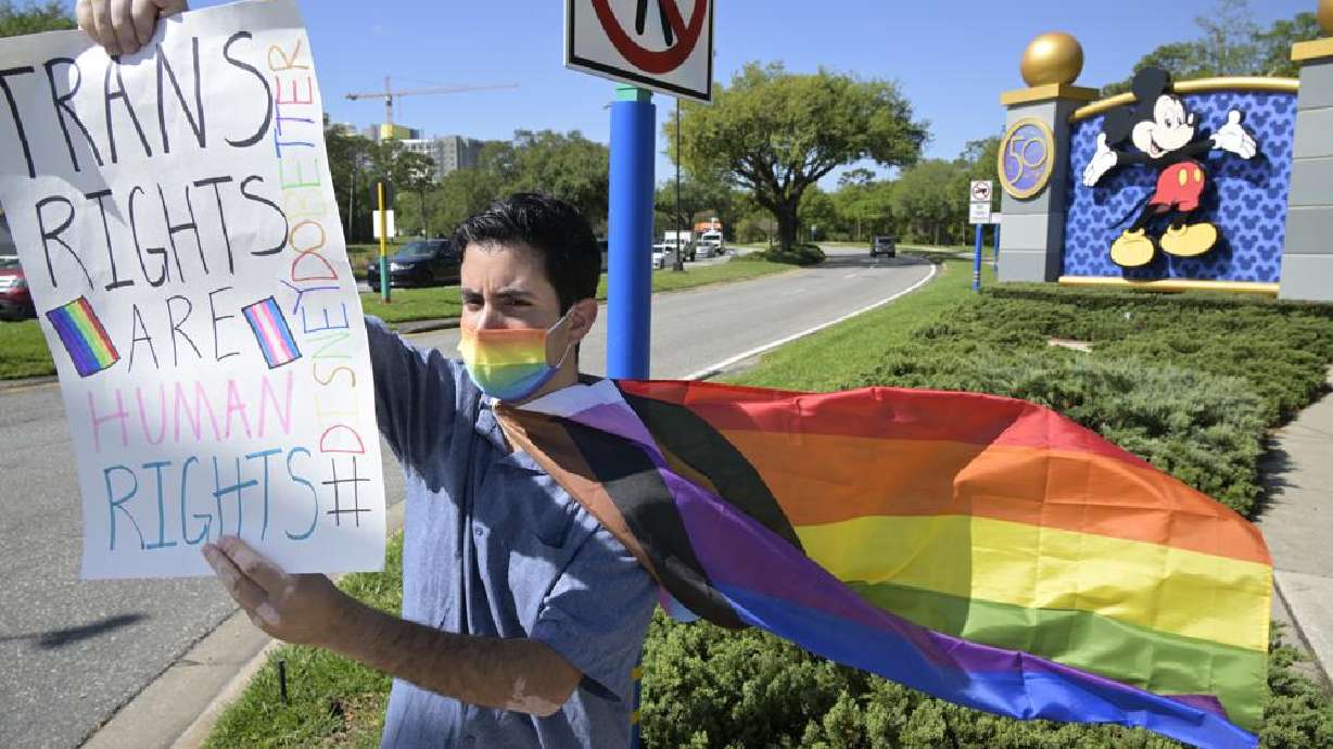 Disney cast member Nicholas Maldonado protests his company's stance on LGBTQ issues, while participating in an employee walkout at Walt Disney World, Tuesday in Lake Buena Vista, Fla.