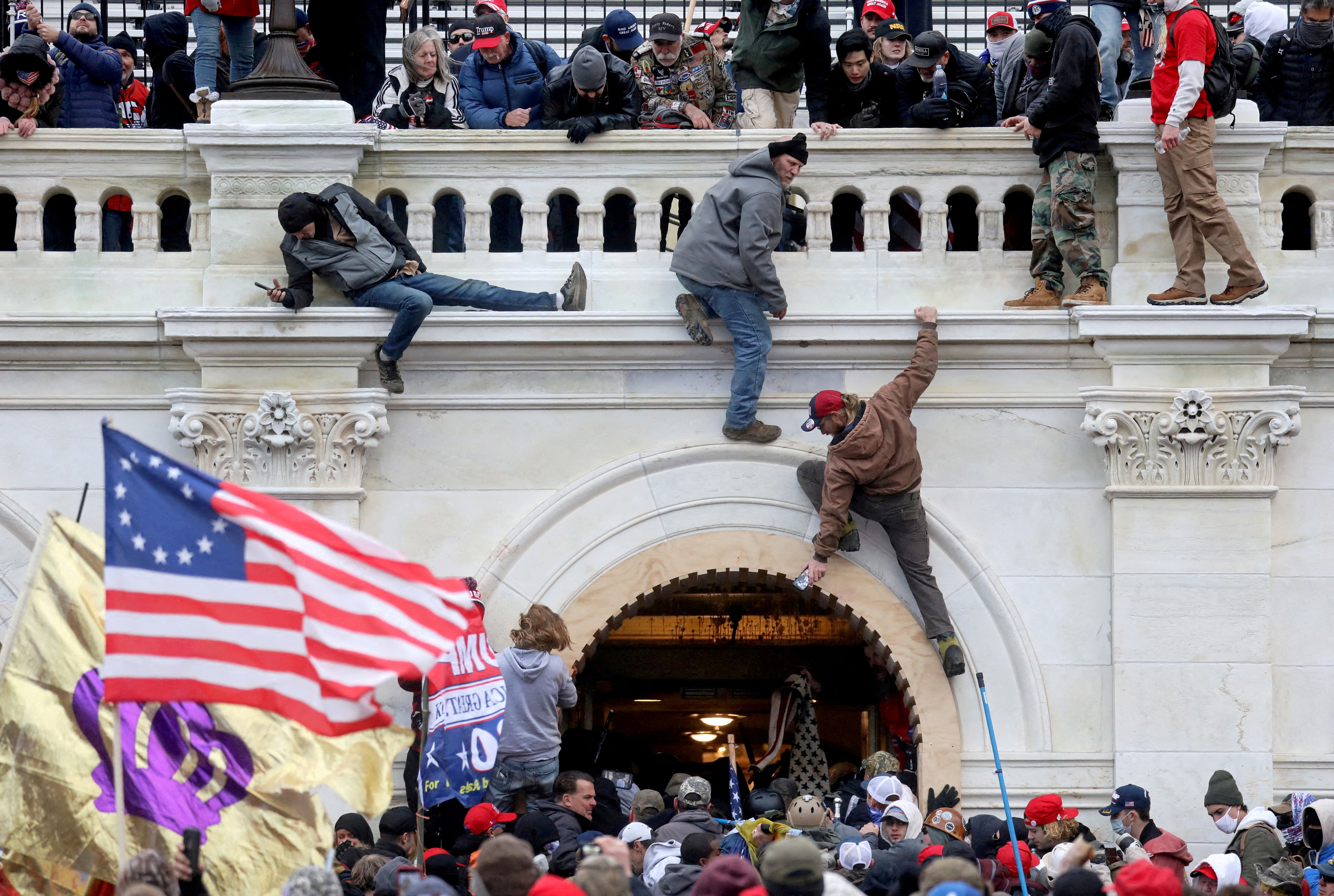A mob of supporters of U.S. President Donald Trump fights with members of law enforcement at a door they broke open as they storm the U.S. Capitol Building in Washington, Jan. 6, 2021. A founder of a group called "Cowboys for Trump" was found guilty by a judge on Tuesday of breaching the U.S. Capitol during the riot.