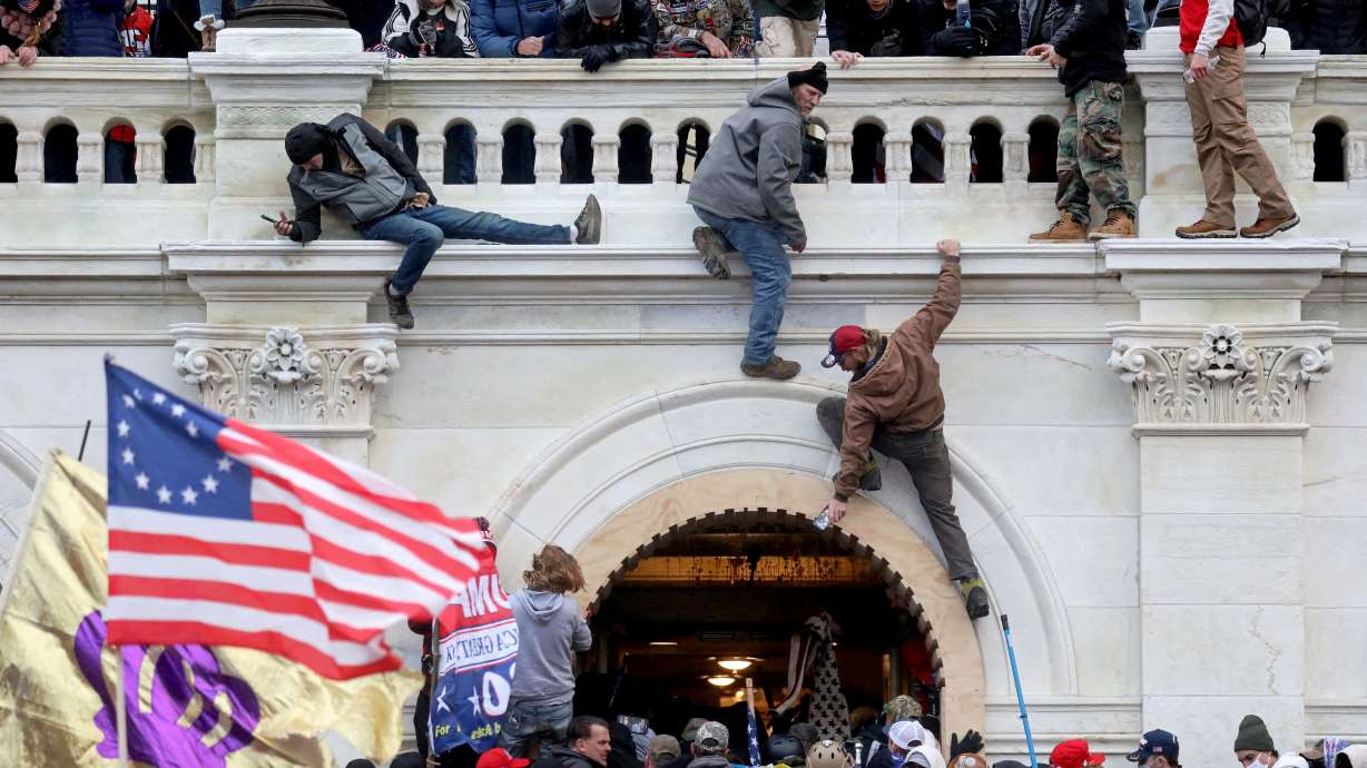 A mob of supporters of U.S. President Donald Trump fights with members of law enforcement at a door they broke open as they storm the U.S. Capitol Building in Washington, Jan. 6, 2021. A founder of a group called "Cowboys for Trump" was found guilty by a judge on Tuesday of breaching the U.S. Capitol during the riot.