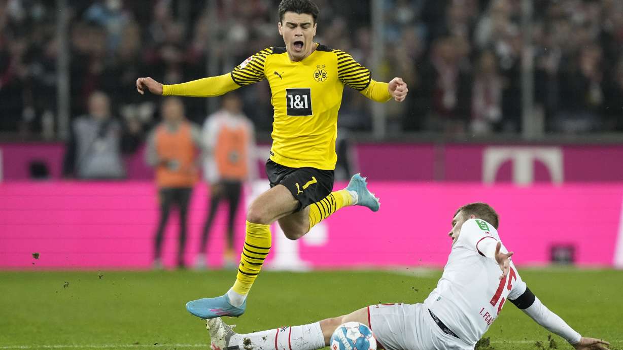 Dortmund's Giovanni Reyna, left, and Cologne's Luca Kilian challenge for the ball during the German Bundesliga soccer match between 1.FC Cologne and Borussia Dortmund in Cologne, Germany, Sunday, March 20, 2022.