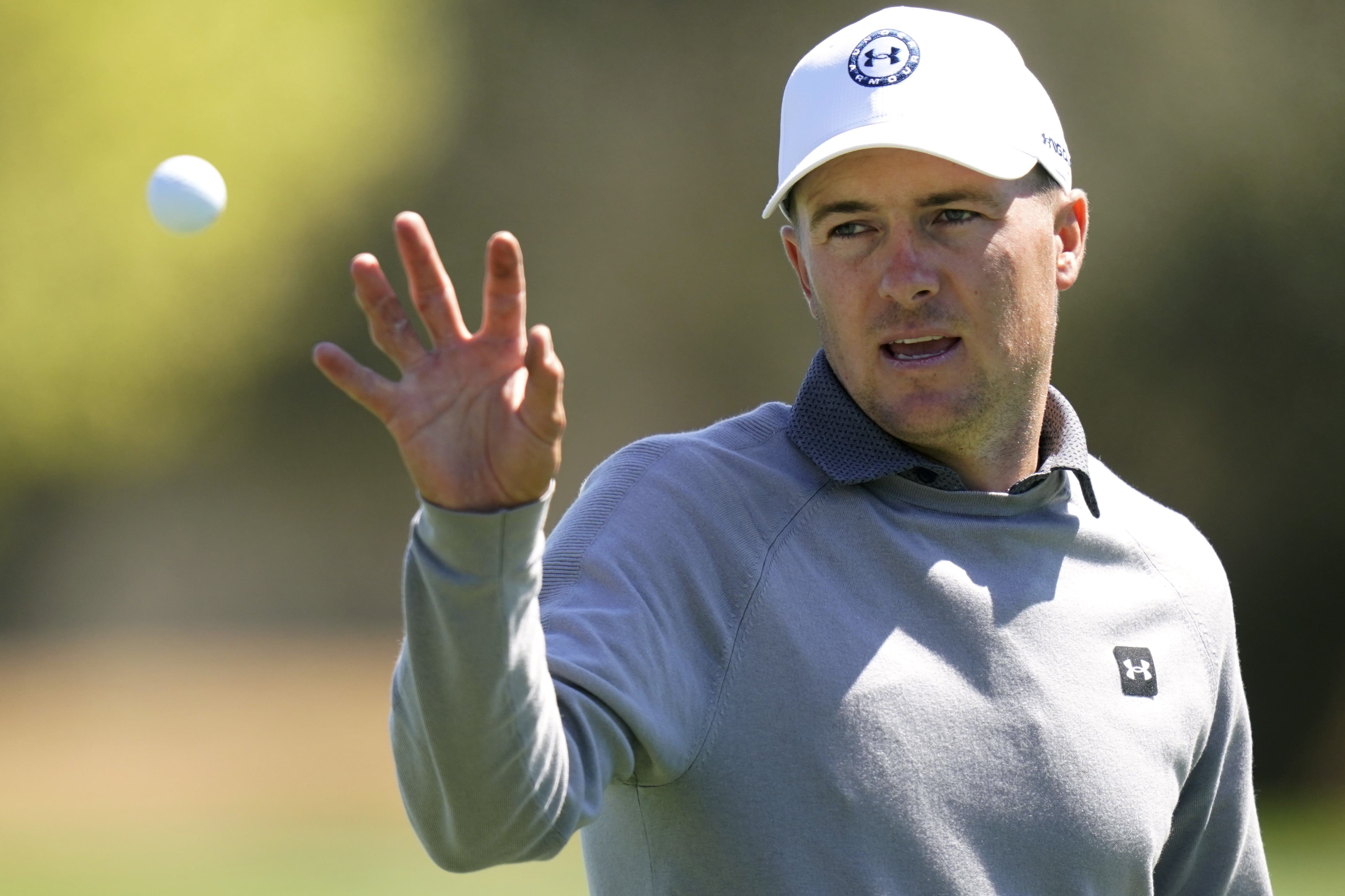 Jordan Spieth reaches for his ball during practice for the Dell Technologies Match Play Championship golf tournament, Tuesday, March 22, 2022, in Austin, Texas. 