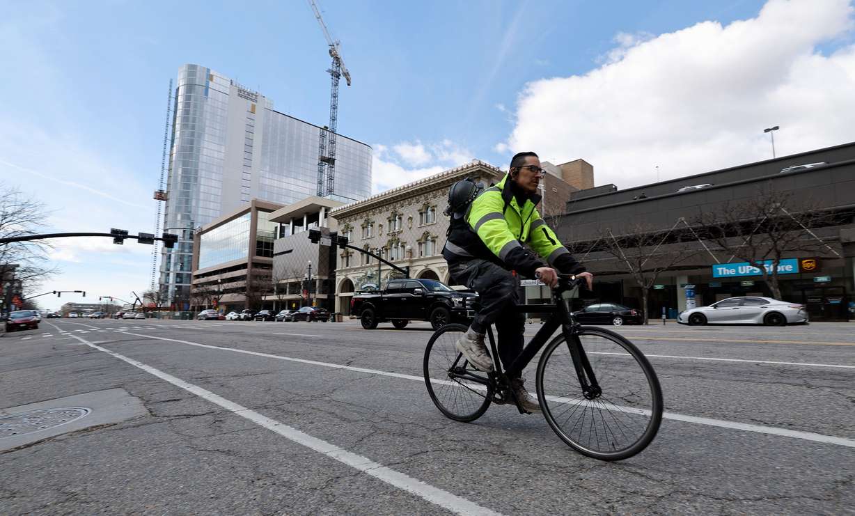 A cyclist rides east on 200 South in Salt Lake City on Tuesday.