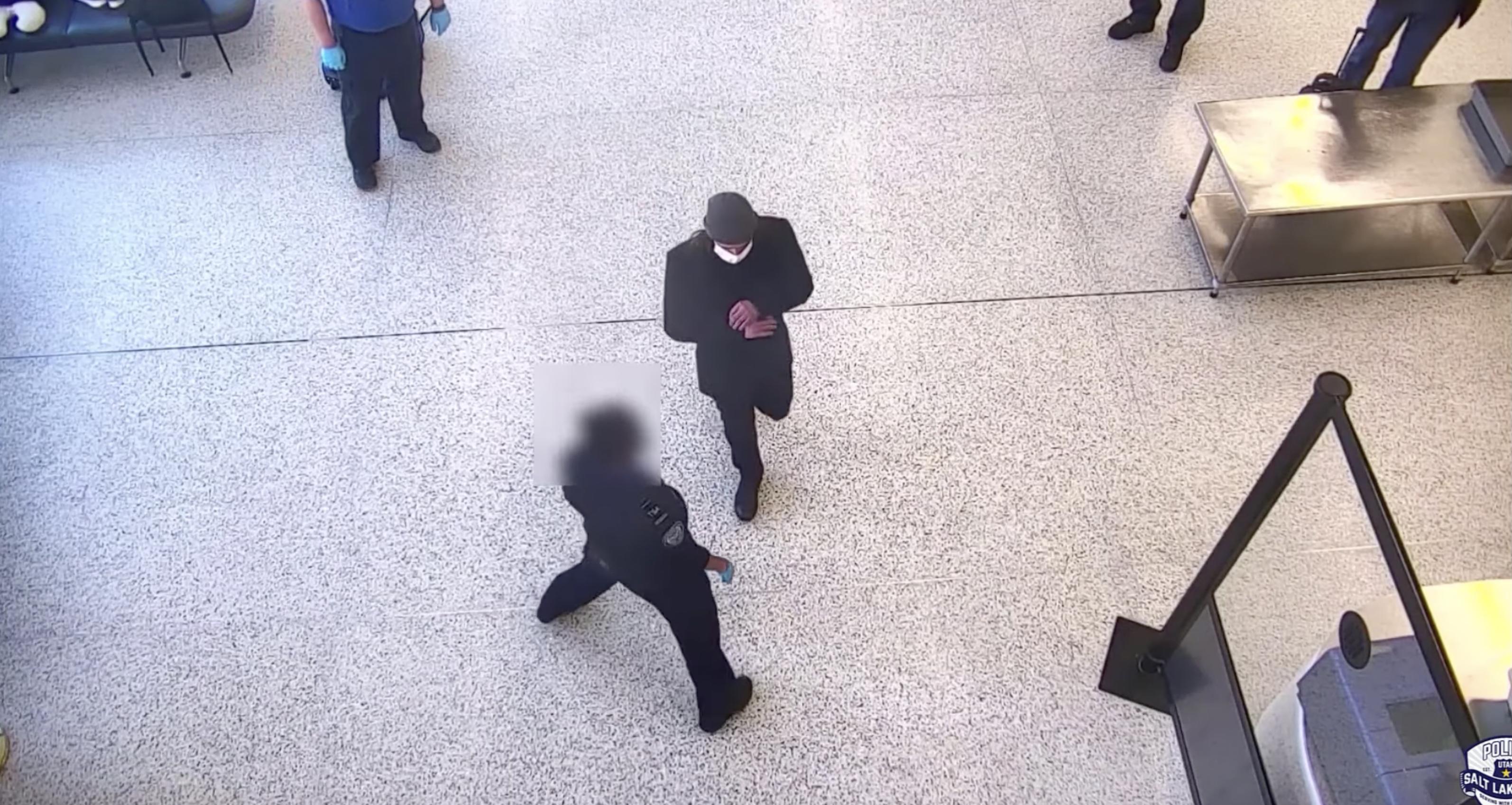Surveillance video shows a man about to walk past a police officer into a secure area at the Salt Lake City International Airport. He was later taken into custody after he physically fought with another officer.
