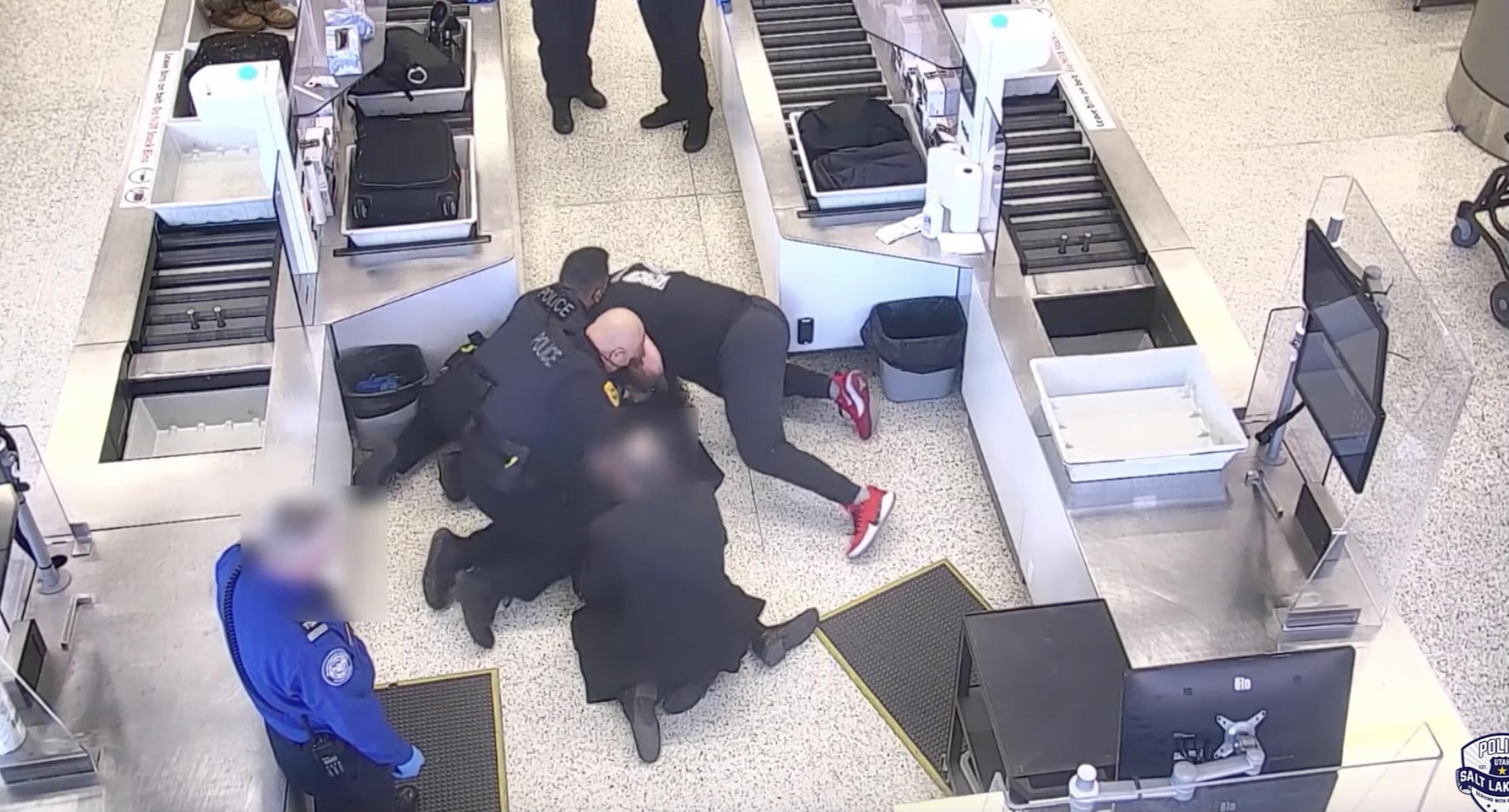Surveillance video shows a man being wrestled to the ground by police officers and a bystander after he breached a secure area at the Salt Lake City International Airport. He was eventually taken into custody.