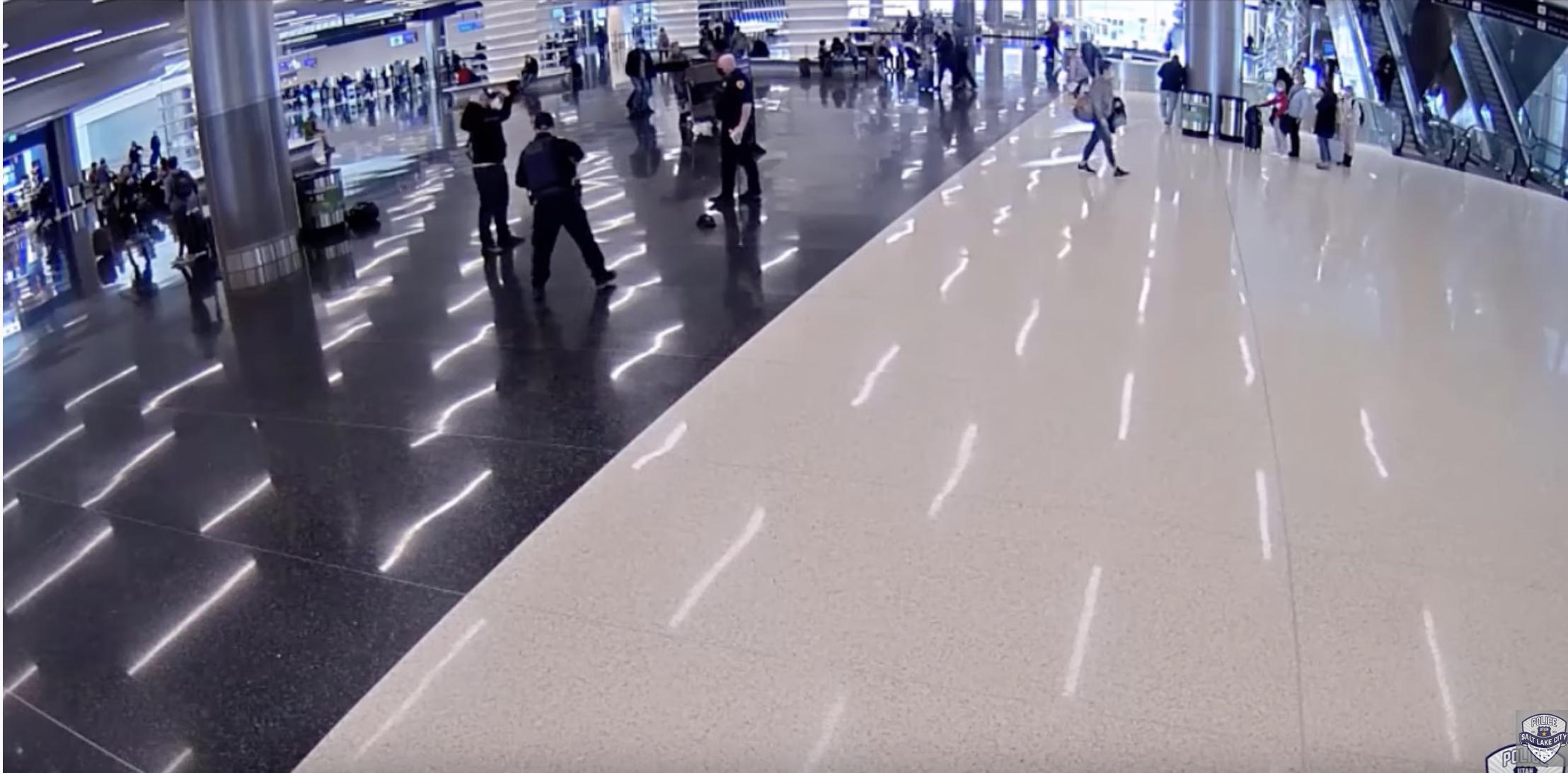 Surveillance video from the Salt Lake International Airport shows a man with his hands in the air seconds after he suckerpunched a Salt Lake City police officer without warning or provocation. He was later arrested and now faces federal charges.