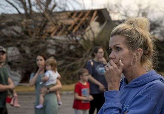 Kristie Wofford looks at the damage after a tornado heavily damaged several homes on Oxford Drive in Round Rock, Texas, on Monday March 21, 2022.