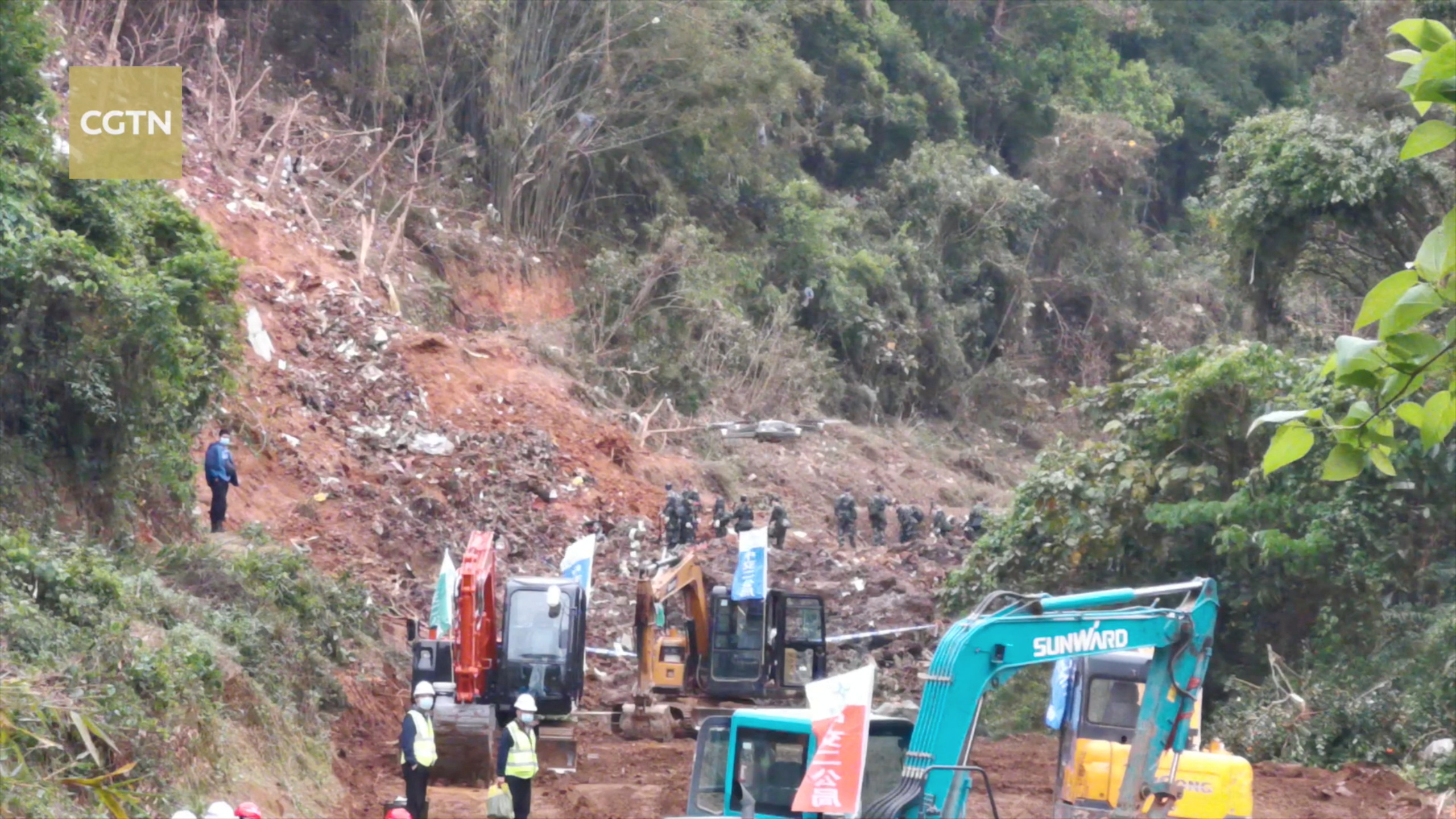 A drone flies over rescuers working at the site where a China Eastern Airlines Boeing 737-800 plane, flight MU5735, crashed in Wuzhou, Guangxi Zhuang Autonomous Region, China, in this still image taken from a footage Wednesday. Chinese searchers found on Wednesday one of two black boxes from a China Eastern Airlines plane that crashed this week in forest-clad mountains with 132 people onboard.