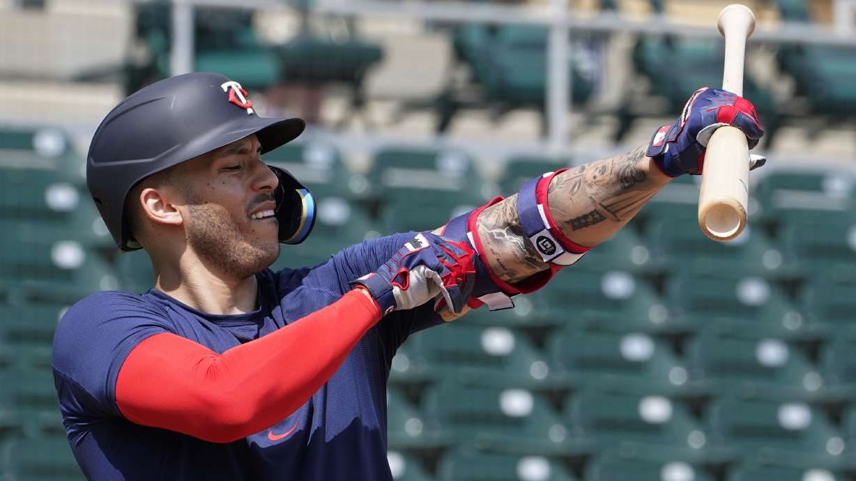 Minnesota Twins' Carlos Correa adjusts his arm protector during batting batting practice at Hammond Stadium Wednesday March 23, 2022, in Fort Myers, Fla.