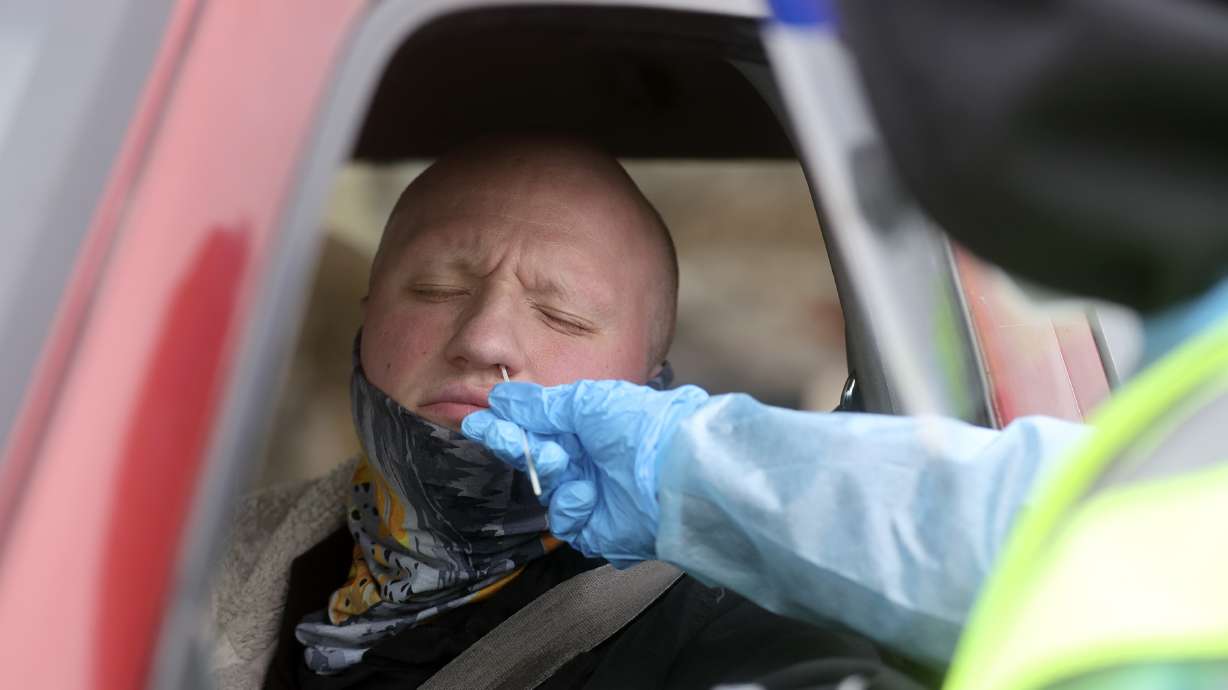 Lucas Atkinson gets tested for COVID-19 at a Nomi Health testing site outside of the Utah Department of Health building in Salt Lake City on March 16. On Wednesday, state health officials reported 119 new COVID cases and 35 deaths, most of which occurred over a month ago.