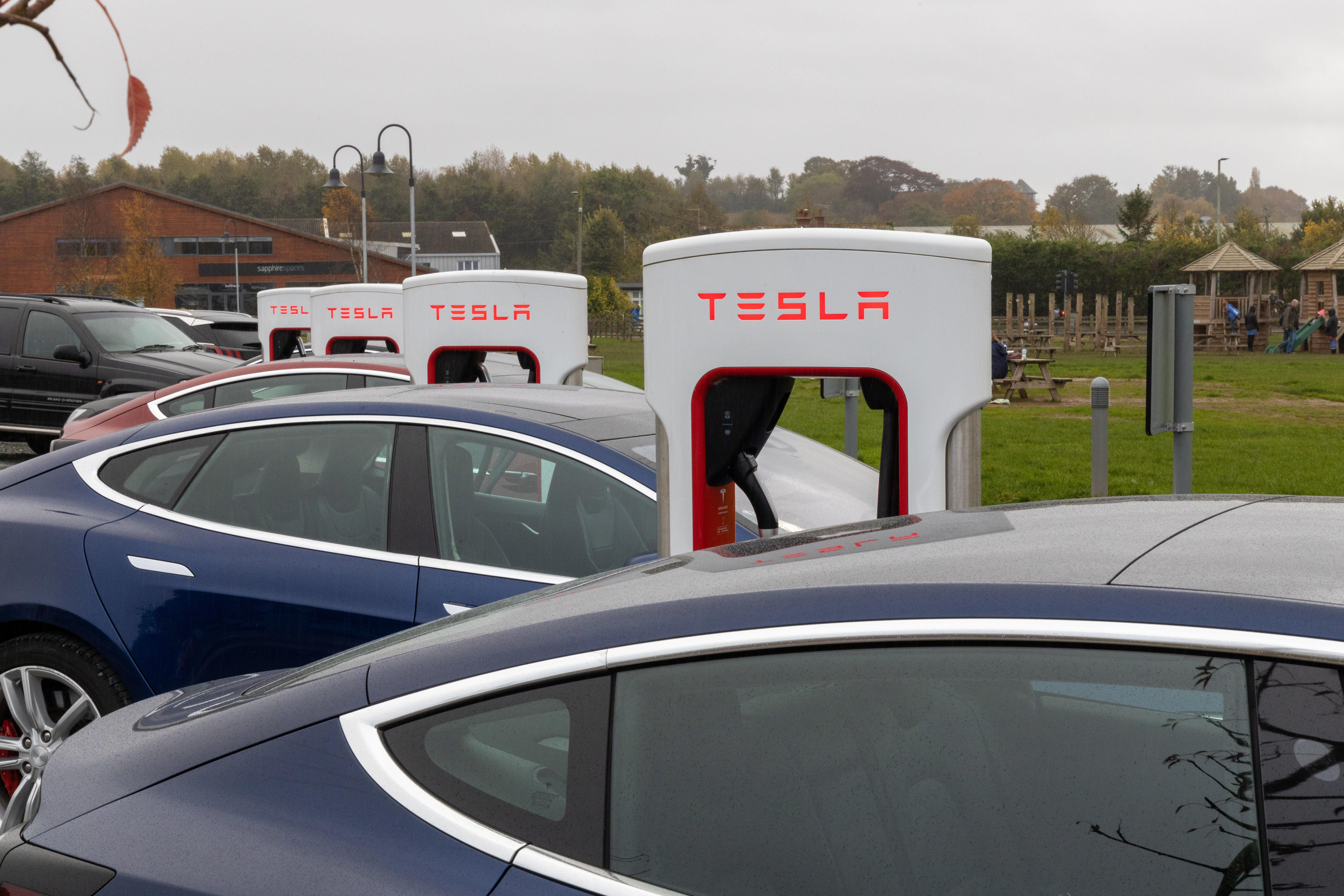 Tesla cars charge Exeter, England on Nov. 2, 2019. Cars, especially electric vehicles, increasingly rely on computers to work so software updates are likely to be increasingly relevant to them. Recalls work differently for newer cars.