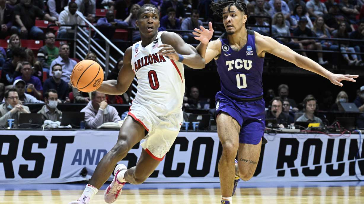 Arizona guard Bennedict Mathurin, left, drives around TCU guard Micah Peavy, right, during the first half of a second-round NCAA college basketball tournament game, Sunday, March 20, 2022, in San Diego.