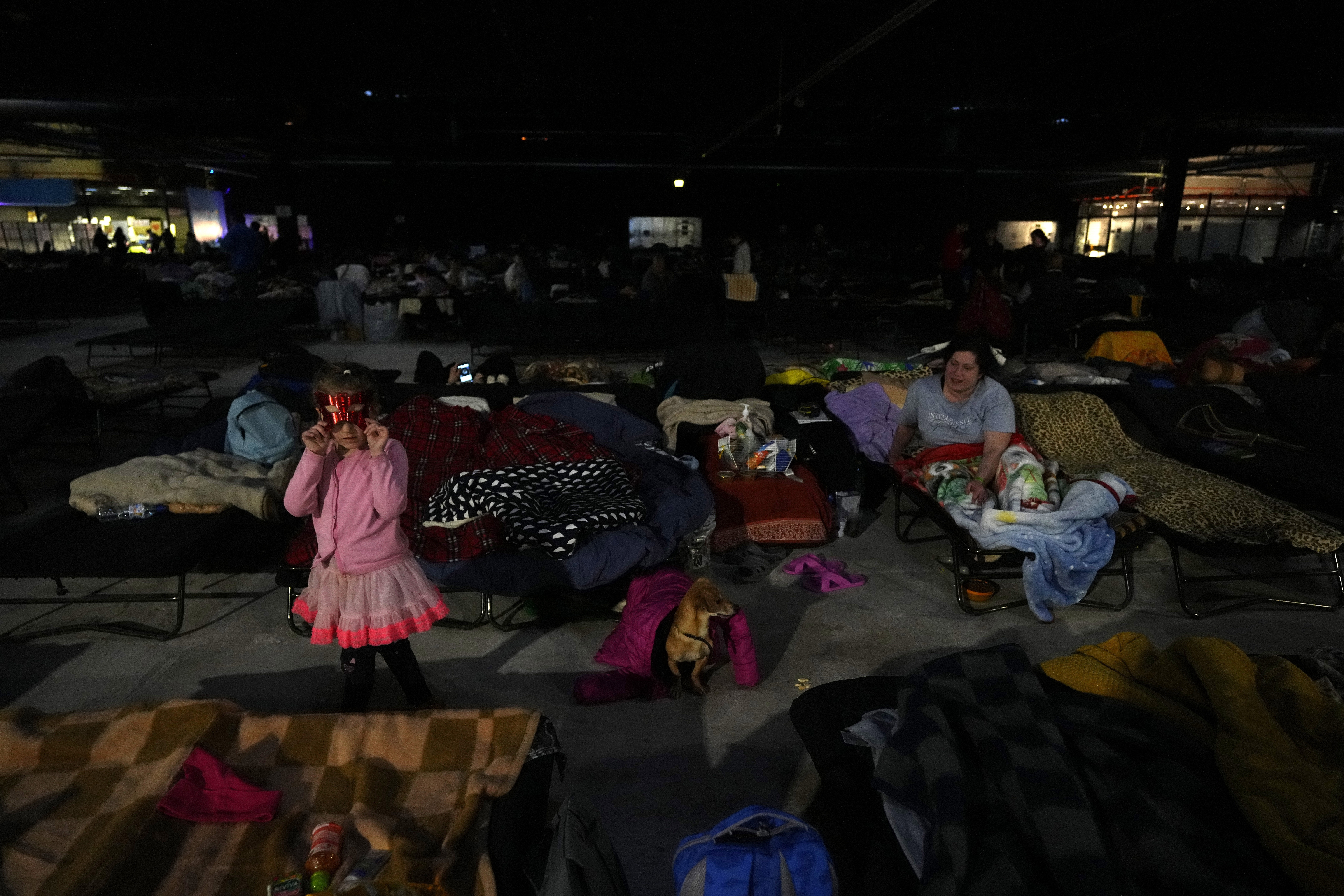 Ukrainians rest at an exhibition hall, turned into a refugee center in Nadarzyn, near Warsaw, Poland, on Wednesday.