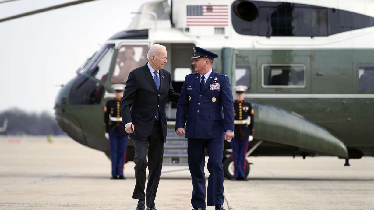 President Joe Biden, escorted by Col. Matthew Jones, commander of 89th Airlift Wing, walks to board Air Force One at Andrews Air Force Base, Md., on Wednesday. Biden is traveling to Europe to meet with World counterparts on Russia’s invasion of Ukraine.