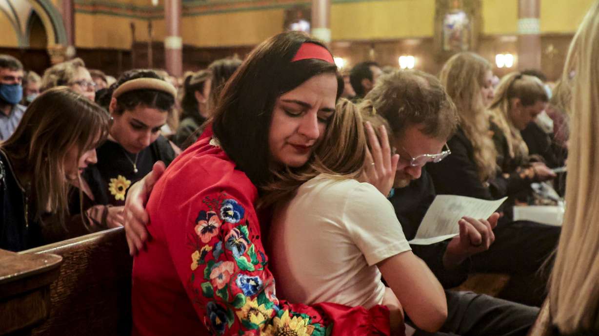 Kateryna Hansen, a Utah Ukrainian resident, hugs her daughter, Zoriana, after giving a speech at the Voices for Ukraine event at the Cathedral of the Madeleine in Salt Lake City on Monday.