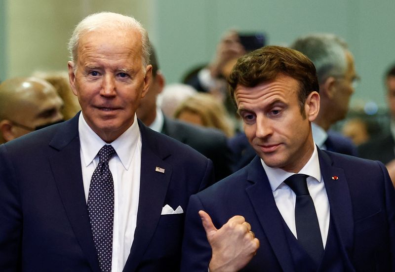 France's President Emmanuel Macron gestures next to U.S. President Joe Biden during a NATO summit to discuss Russia's invasion of Ukraine, at the alliance's headquarters in Brussels, Belgium, Thursday.