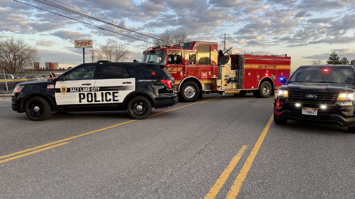 Salt Lake City police vehicles are pictured at the scene of a double fatal crash that took place Thursday morning on Redwood Road.