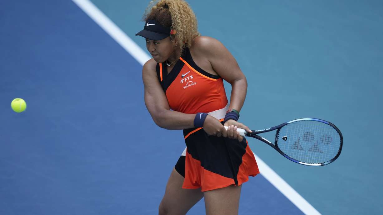Naomi Osaka of Japan plays a ball in her second round women's match against Angelique Kerber of Germany at the Miami Open tennis tournament, Thursday, March 24, 2022, in Miami Gardens, Fla.