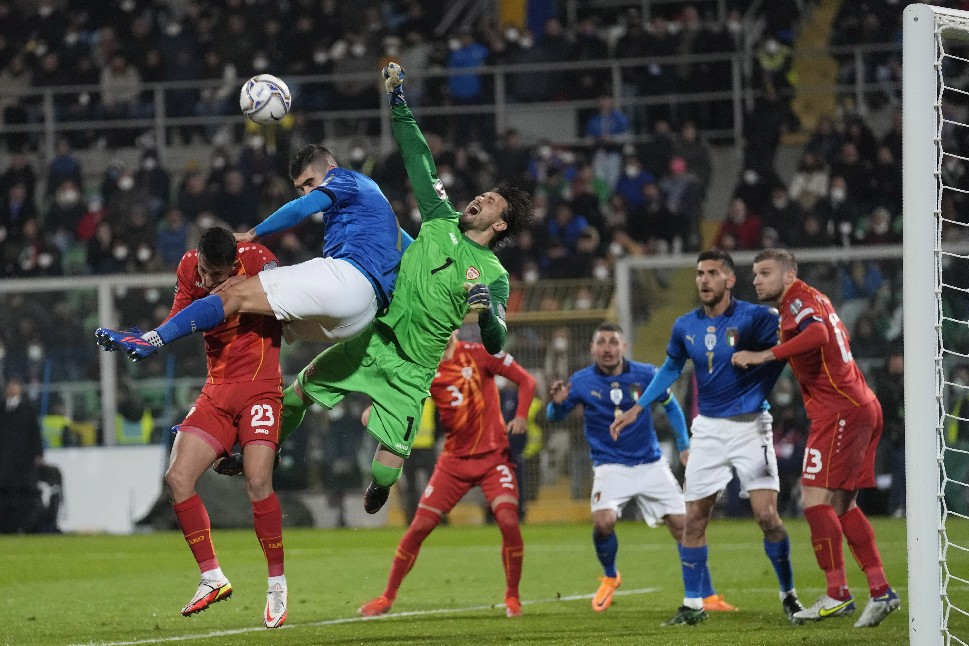 North Macedonia's goalkeeper Stole Dimitrievski saves on attempt to score by Italy's Gianluca Mancini during the World Cup qualifying play-off soccer match between Italy and North Macedonia, at Renzo Barbera stadium, in Palermo, Italy, Thursday, March 24, 2022.