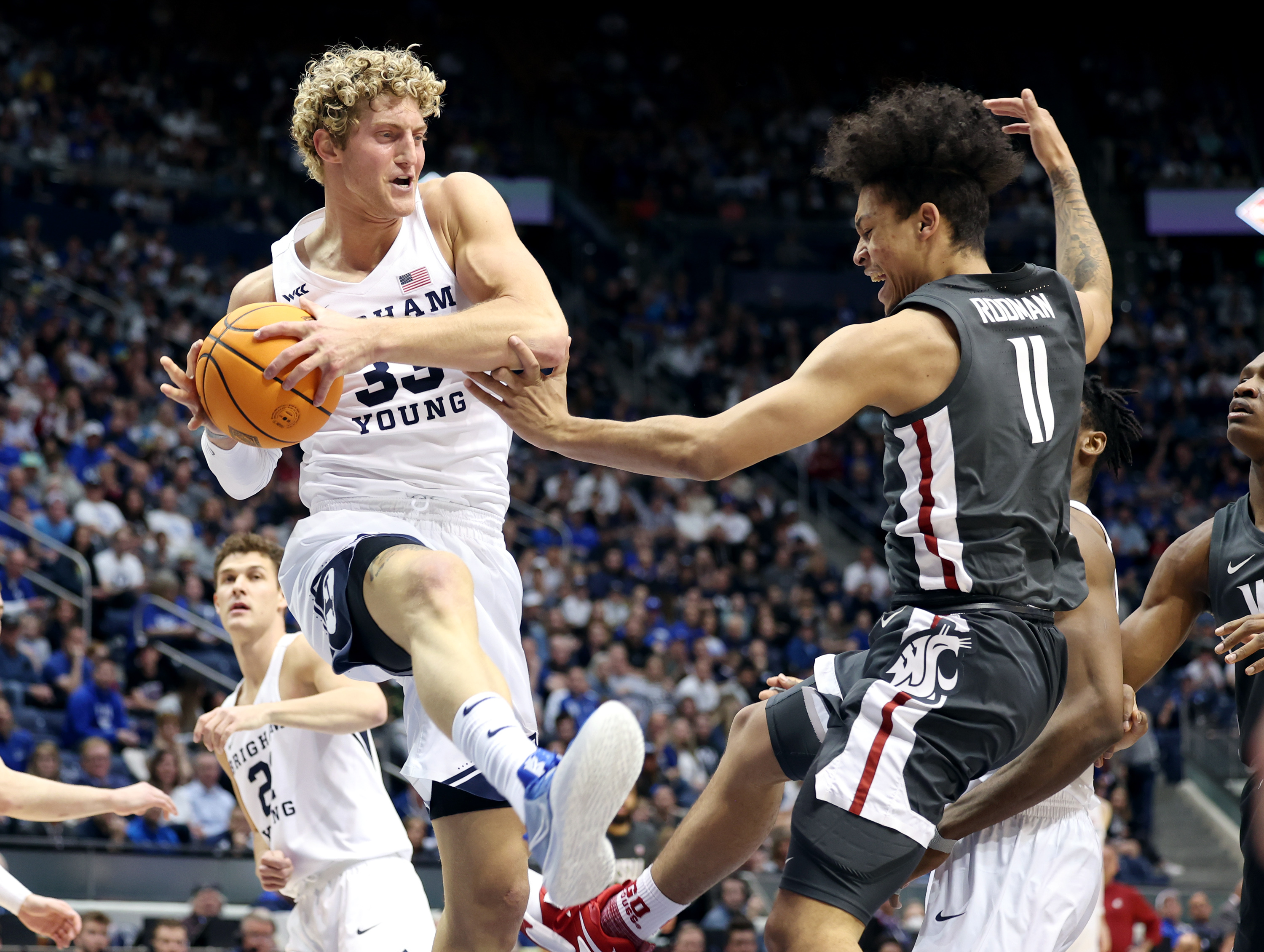 Brigham Young forward Caleb Lohner (33) snags a rebound away from Washington State forward DJ Rodman (11) as BYU and Washington State play in the NIT quarterfinals at the Marriott Center in Provo on Wednesday, March 23, 2022. Washington State won 77-58.