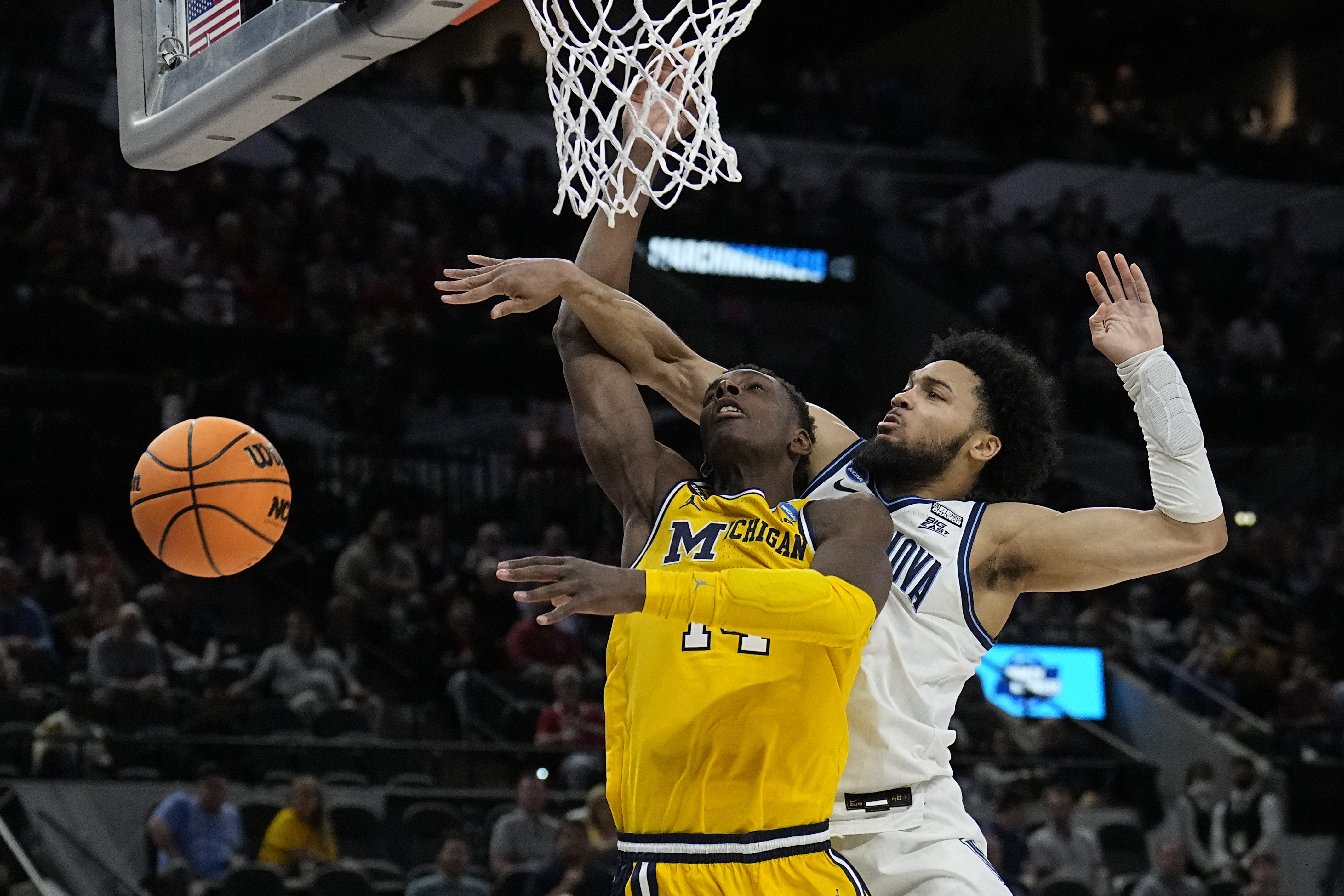 Villanova guard Caleb Daniels, right, fouls Michigan forward Moussa Diabate during the second half of a college basketball game in the Sweet 16 round of the NCAA tournament on Thursday, March 24, 2022, in San Antonio. 