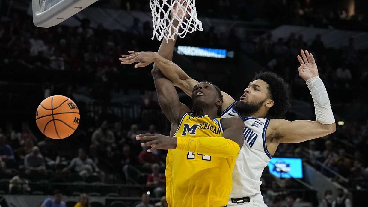 Villanova guard Caleb Daniels, right, fouls Michigan forward Moussa Diabate during the second half of a college basketball game in the Sweet 16 round of the NCAA tournament on Thursday, March 24, 2022, in San Antonio.