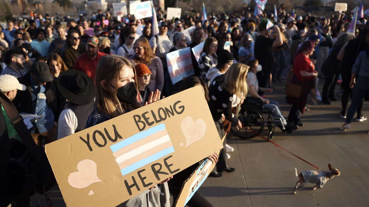 Anika Bateman holds a “You belong here” sign during a rally to support transgender youths outside of the Capitol in Salt Lake City on Thursday, March 24, 2022.