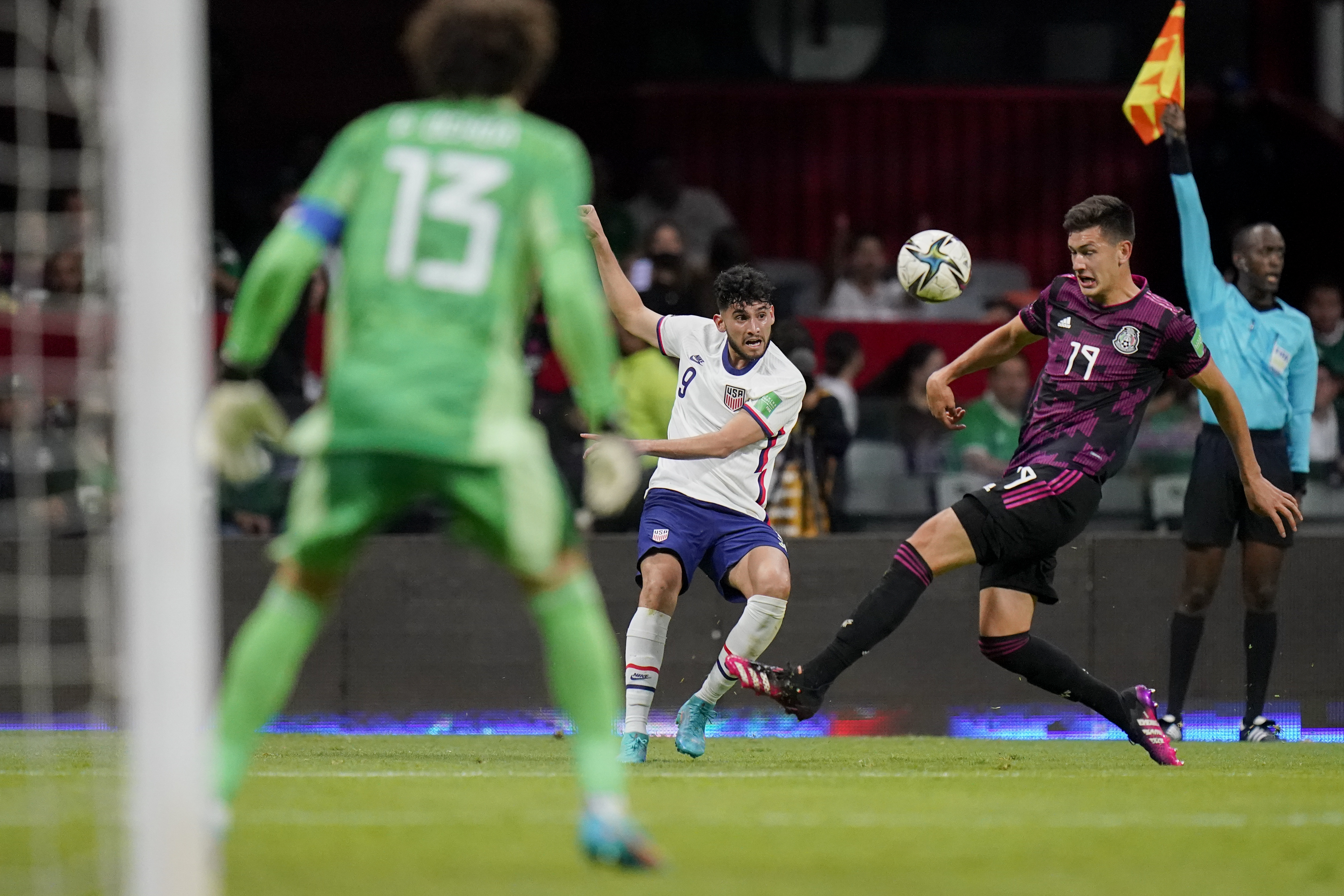United States' Ricardo Pepi, center, and Mexico's Cesar Montes (19) compete for the ball during a qualifying soccer match for the FIFA World Cup Qatar 2022 at Azteca stadium in Mexico City, Thursday, March 24, 2022.
