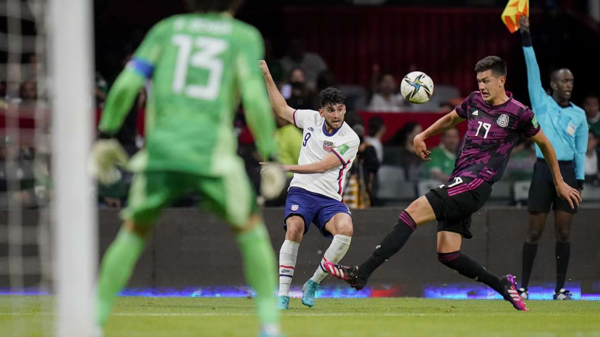 United States' Ricardo Pepi, center, and Mexico's Cesar Montes (19) compete for the ball during a qualifying soccer match for the FIFA World Cup Qatar 2022 at Azteca stadium in Mexico City, Thursday, March 24, 2022.