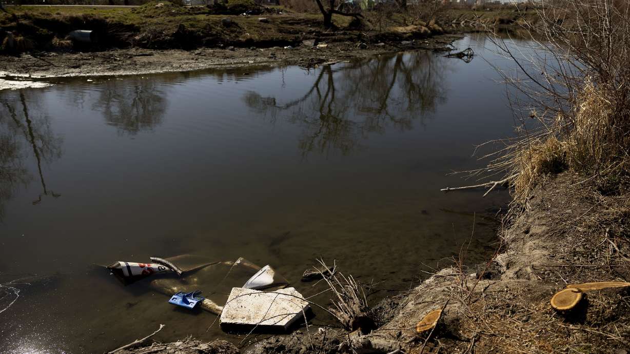 Garbage floats in the Jordan River in Salt Lake City on Wednesday. This year marks the 50th anniversary of the Clean Water Act, which promised fishable and swimmable waterways by 1983. Utah ranks among the top three states for polluted rivers impacting aquatic life