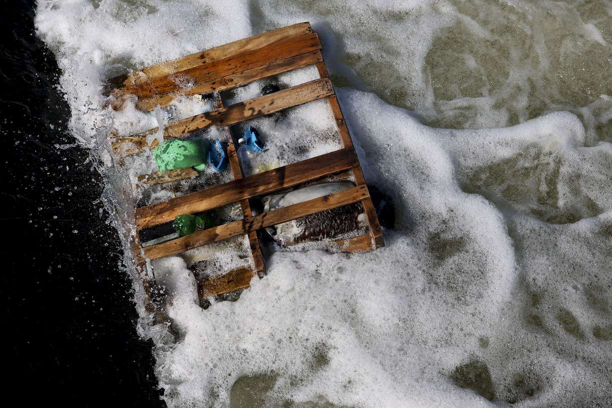 Garbage and a dead animal are pictured in the Jordan River in Salt Lake City on Wednesday.