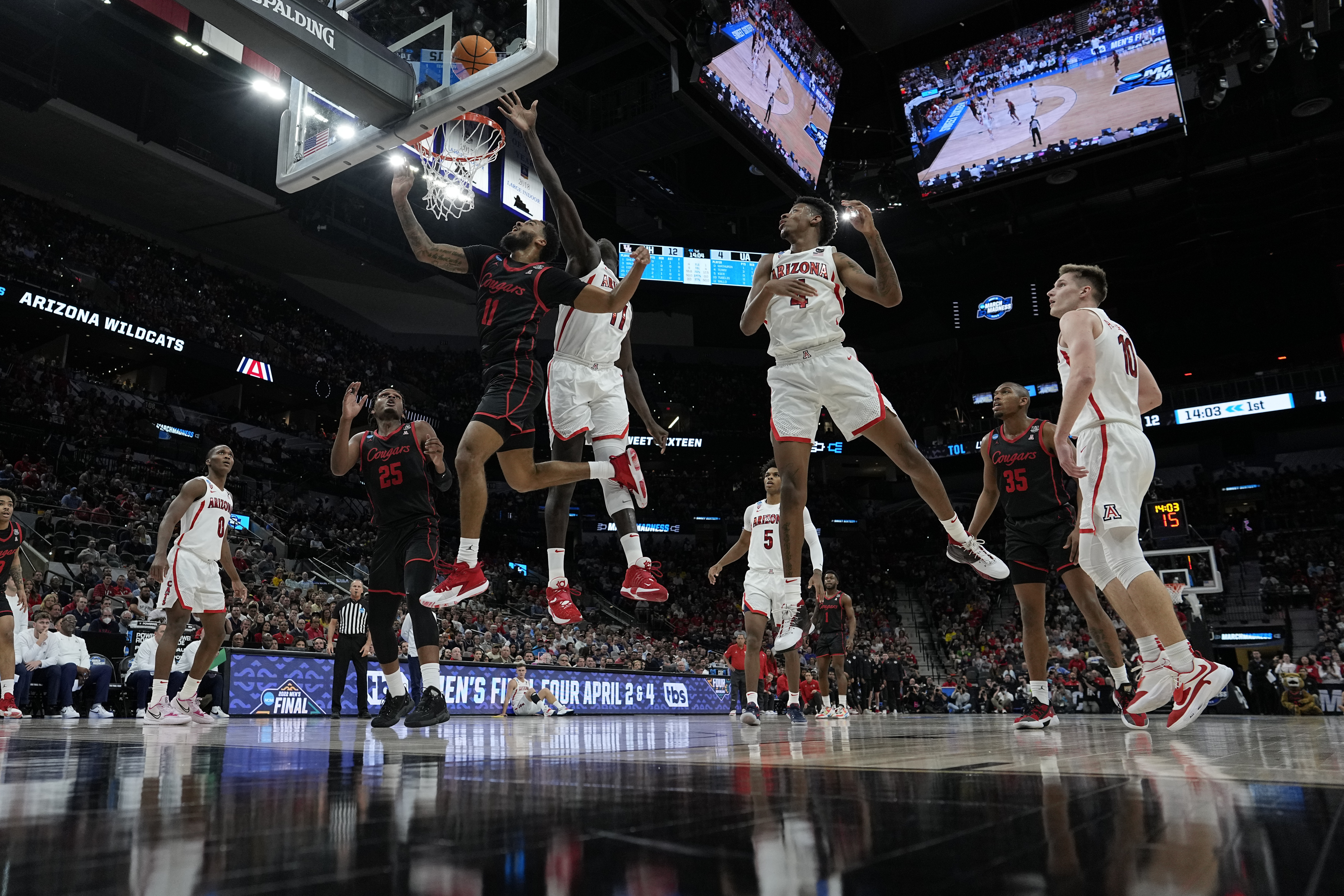 Arizona center Oumar Ballo shoots past Houston guard Kyler Edwards during the first half of a college basketball game in the Sweet 16 round of the NCAA tournament on Thursday, March 24, 2022, in San Antonio.