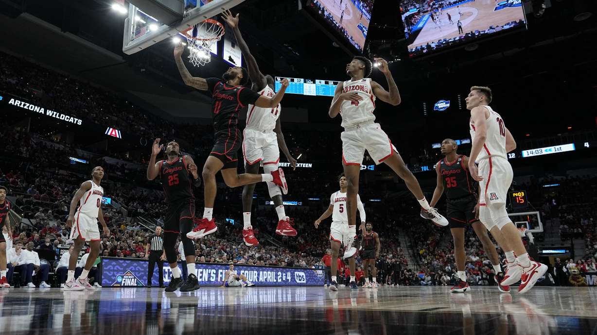 Arizona center Oumar Ballo shoots past Houston guard Kyler Edwards during the first half of a college basketball game in the Sweet 16 round of the NCAA tournament on Thursday, March 24, 2022, in San Antonio.