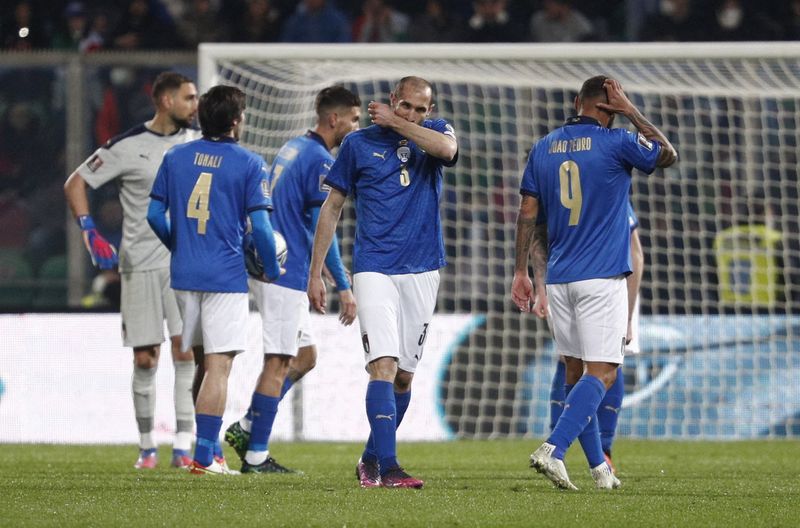 FILE PHOTO: Soccer Football - World Cup - UEFA Qualifiers - Play-Off Semi Final - Italy v North Macedonia - Stadio Renzo Barbera, Palermo, Italy - March 24, 2022 Italy's Giorgio Chiellini and teammates look dejected after the match