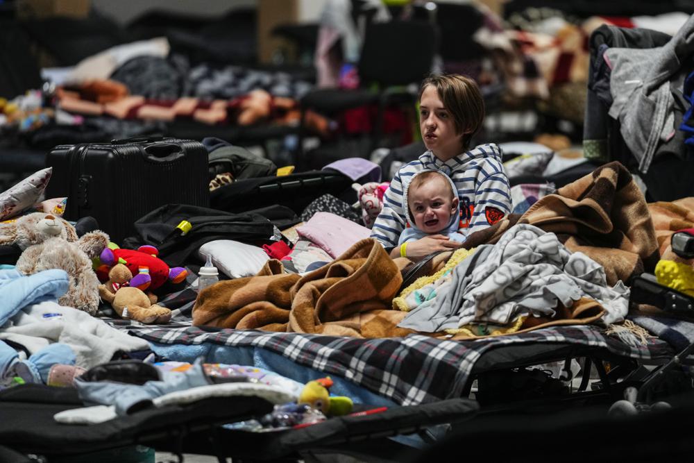 Children sit in a refugee center in Nadarzyn, near Warsaw, Poland, on Friday. U.S. President Joe Biden visited Poland on Friday for the final leg of his four-day trip as he tries to maintain unity among allies and support Ukraine's defense.
