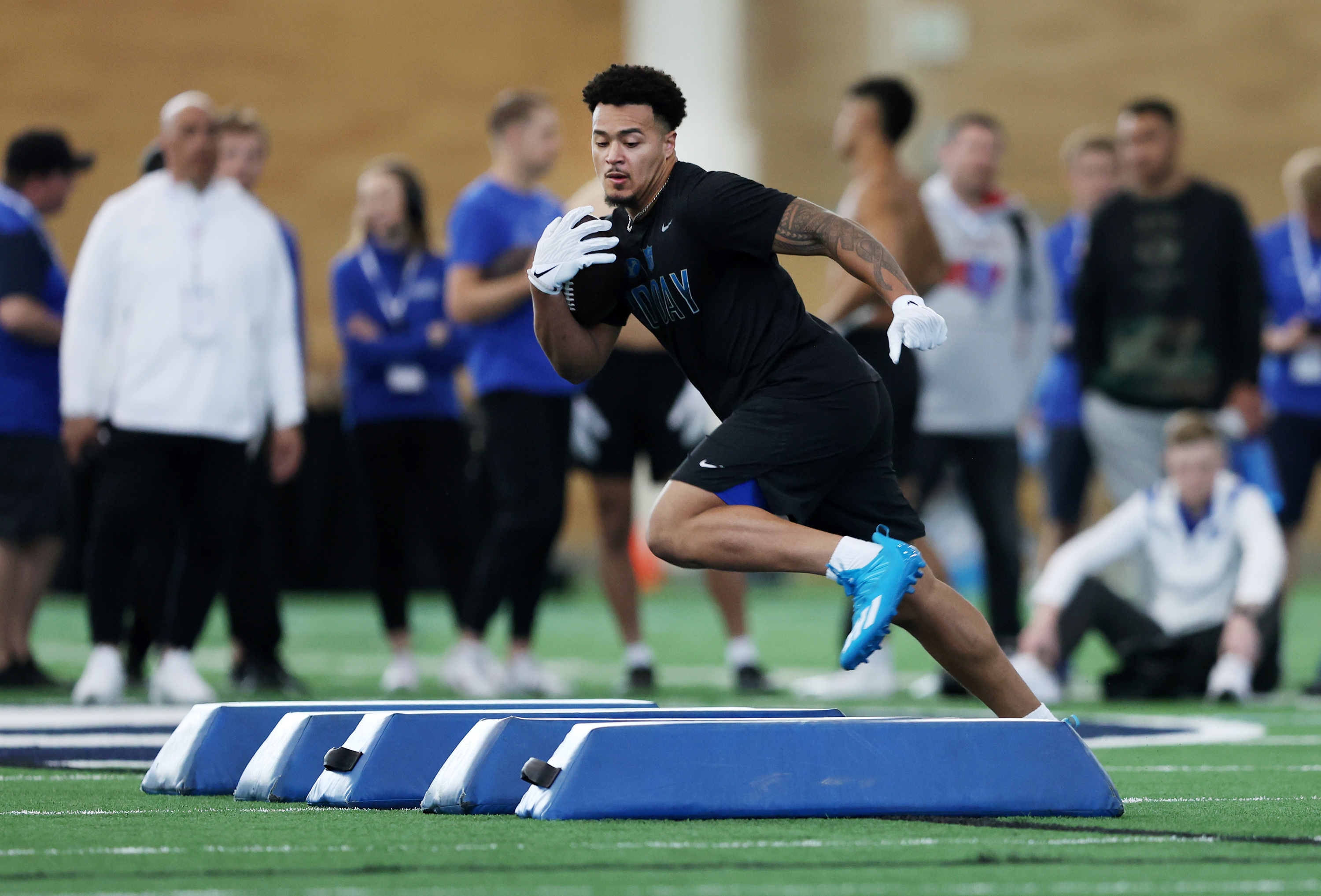 BYU running back Tyler Allgeier runs through a drill during BYU's pro day at the university's indoor practice facility in Provo on Friday, March 25, 2022.
