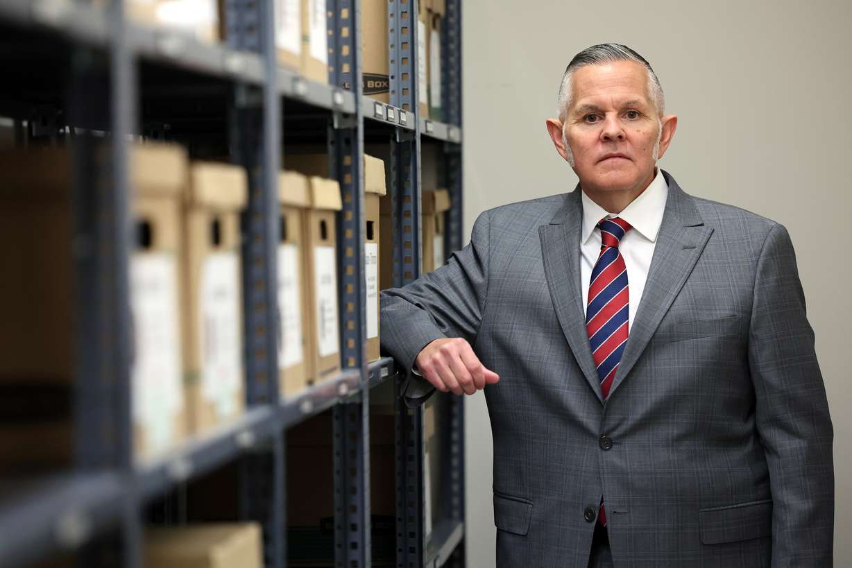 Unified Police detective Ben Pender, who is assigned to the cold case unit, poses for photos in the cold case file room after an interview at the Salt Lake County Sheriff’s Office in South Salt Lake on Tuesday, March 22.