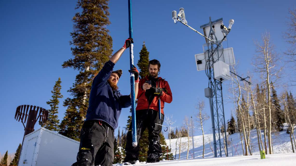 Justin Byington and Dave Eiriksson, both hydrologists for the Utah Snow Survey, demonstrate how they take snow core samples during a media tour of the Utah Snow Survey’s Powder Mountain SNOTEL Site at the ski resort in Eden on Thursday.
