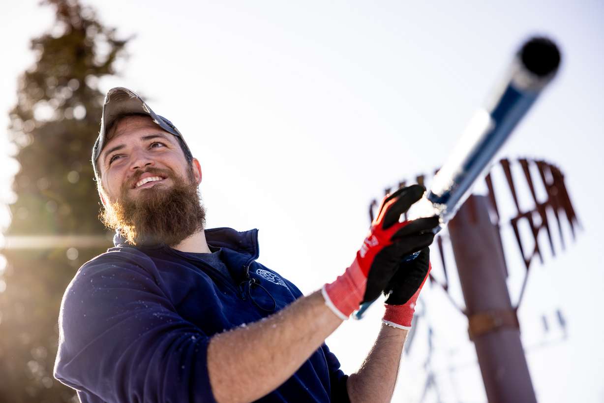 Justin Byington, a hydrologist for the Utah Snow Survey, demonstrates how to take snow core samples during a media tour of the Utah Snow Survey’s Powder Mountain SNOTEL Site at the ski resort in Eden on Thursday.
