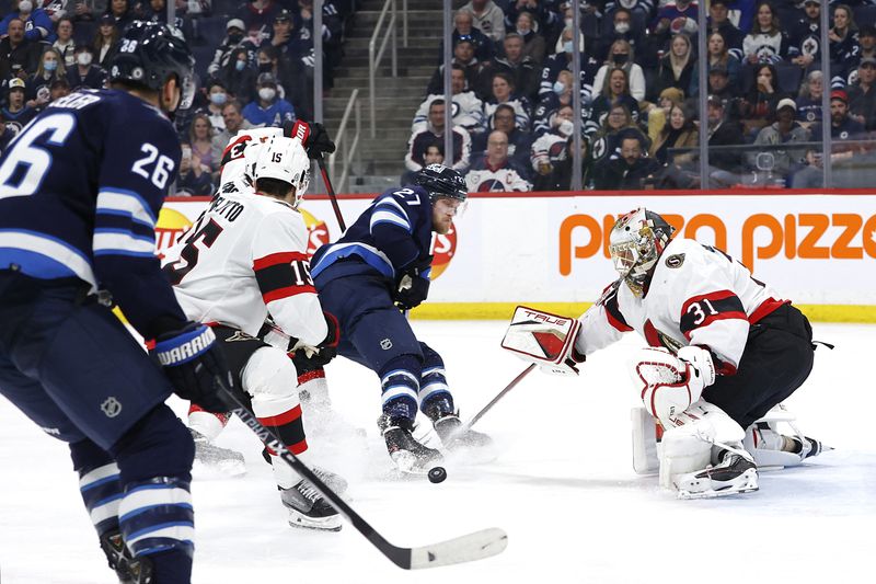 Mar 24, 2022; Winnipeg, Manitoba, CAN; Ottawa Senators goaltender Anton Forsberg (31) blocks a shot from Winnipeg Jets left wing Nikolaj Ehlers (27) in the second period at Canada Life Centre. / James Carey Lauder-USA TODAY Sports