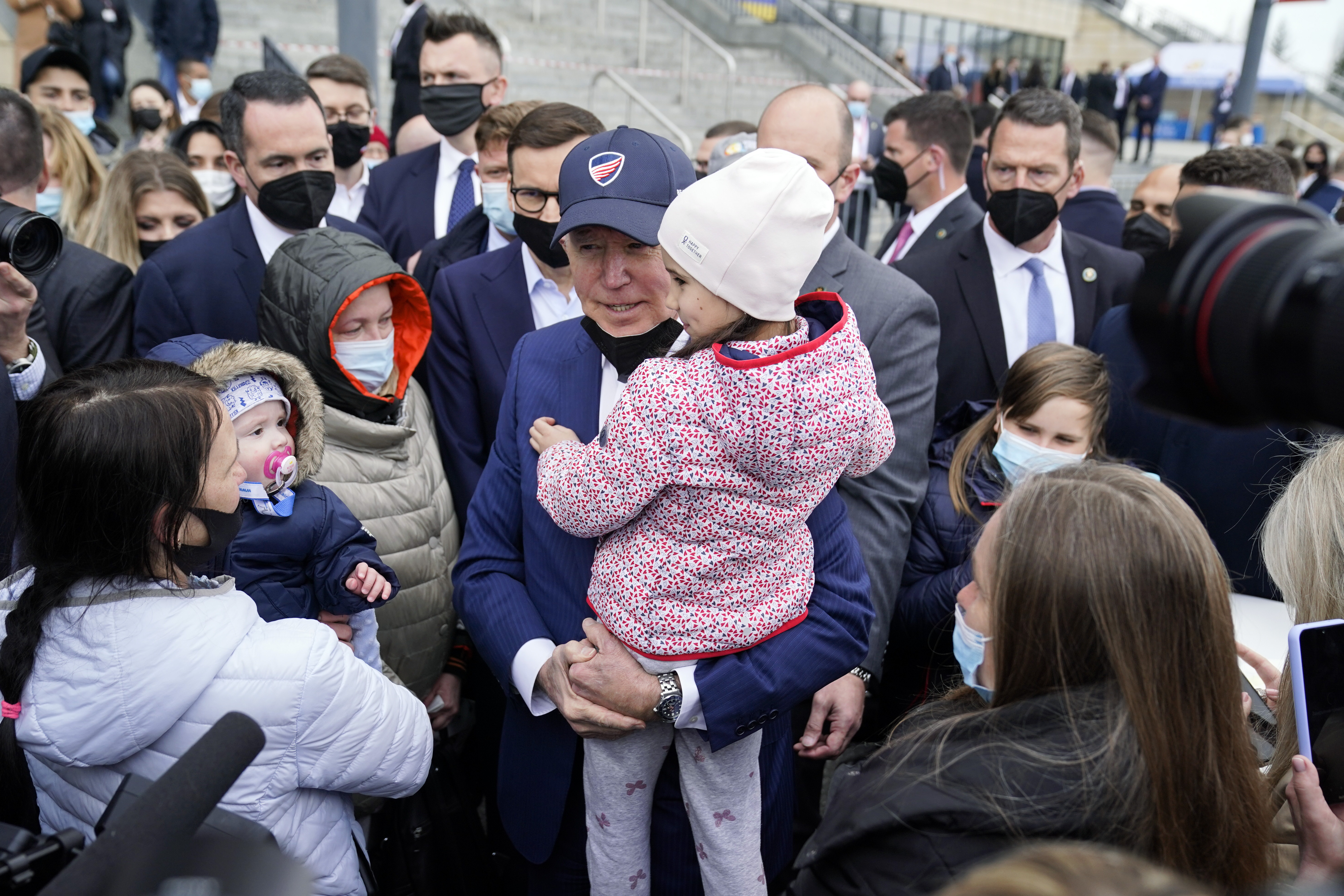 President Joe Biden meets with Ukrainian refugees and humanitarian aid workers during a visit to PGE Narodowy Stadium, Saturday, in Warsaw.