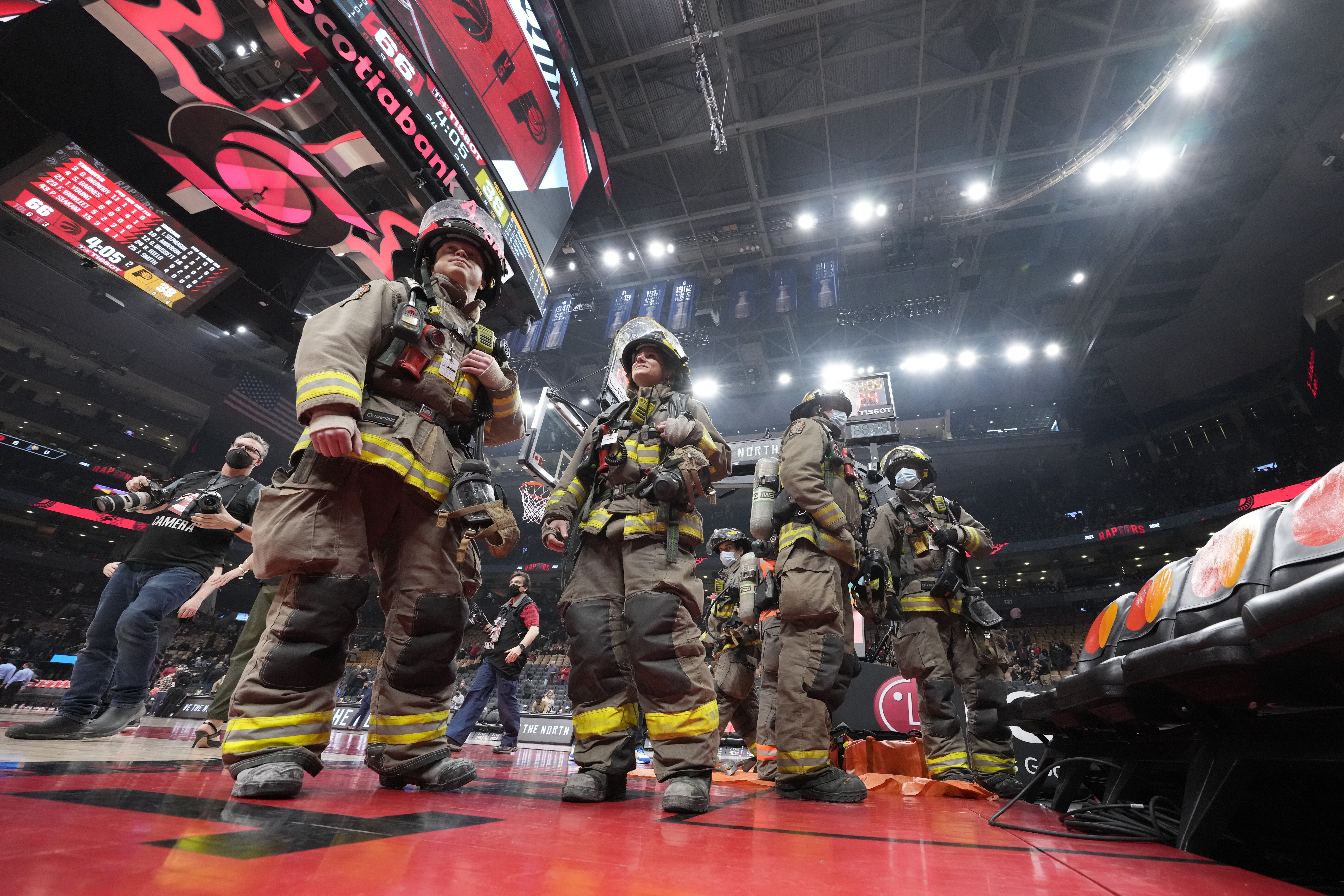 The NBA basketball game is suspended between the Toronto Raptors and the Indiana Pacers as firefighters work to evacuate the building during the first half Saturday, March 26, 2022, in Toronto. 
