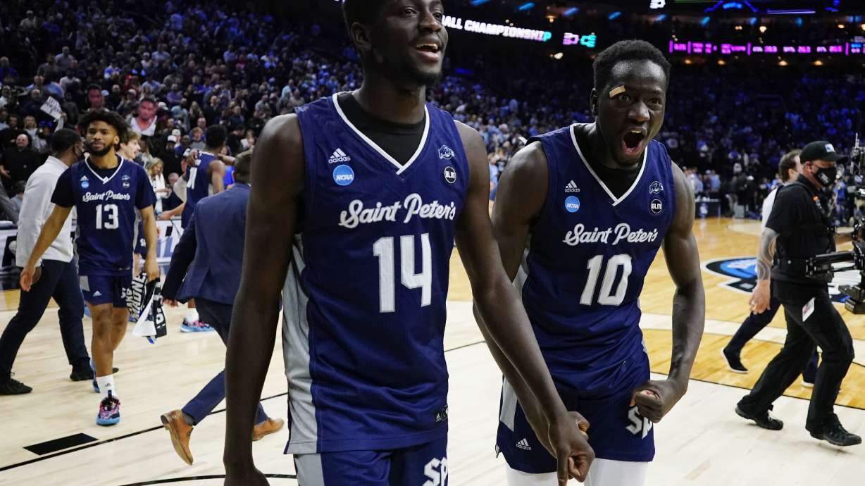 Saint Peter's Fousseyni Drame (10) and Hassan Drame (14) react after Saint Peter's won a college basketball game against Purdue in the Sweet 16 round of the NCAA tournament, Friday, March 25, 2022, in Philadelphia.