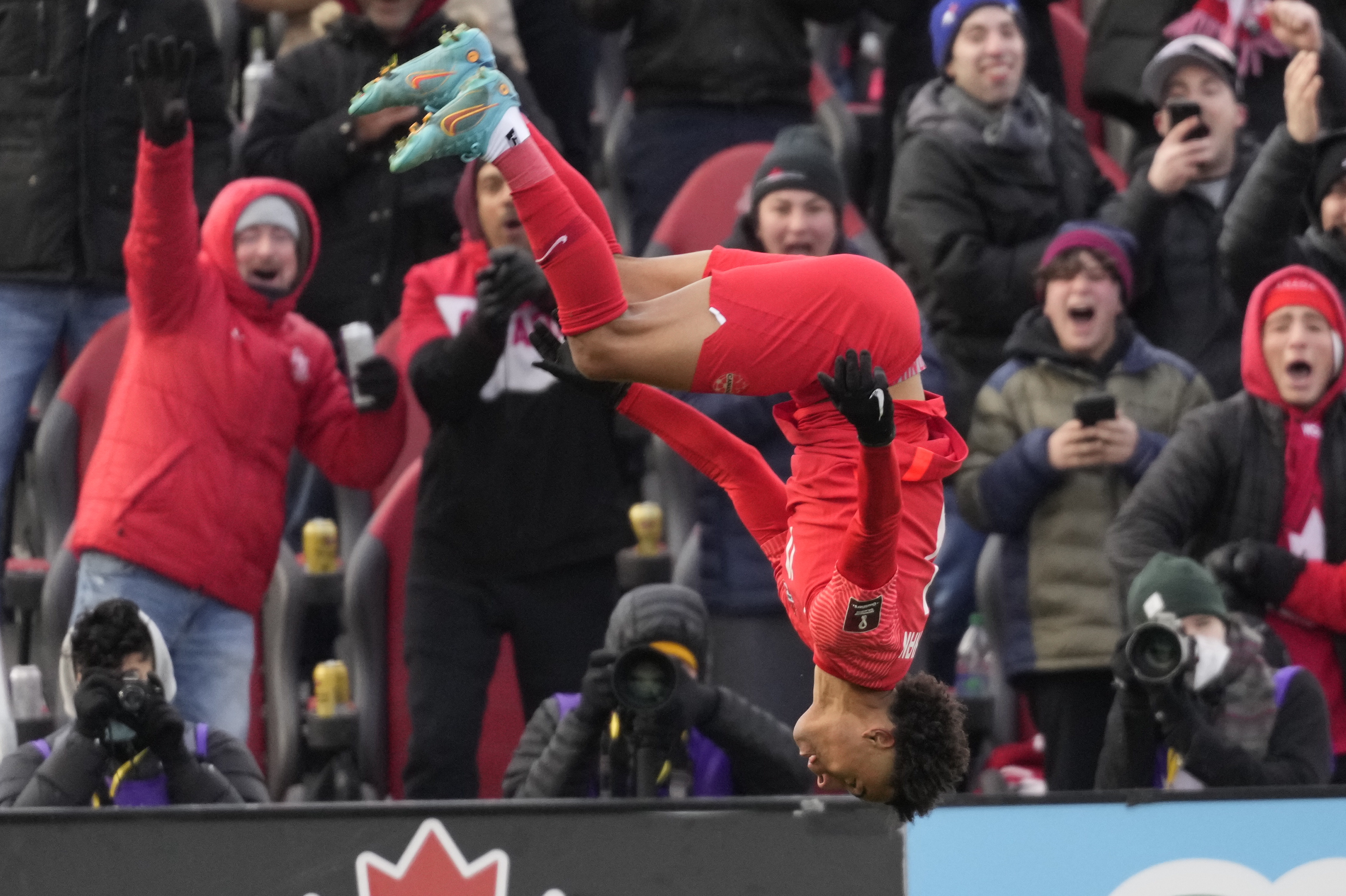 Canada's Tajon Buchanan does a backflip after scoring against Jamaica during first-half CONCACAF World Cup soccer qualifying action in Toronto, Sunday, March 27, 2022.