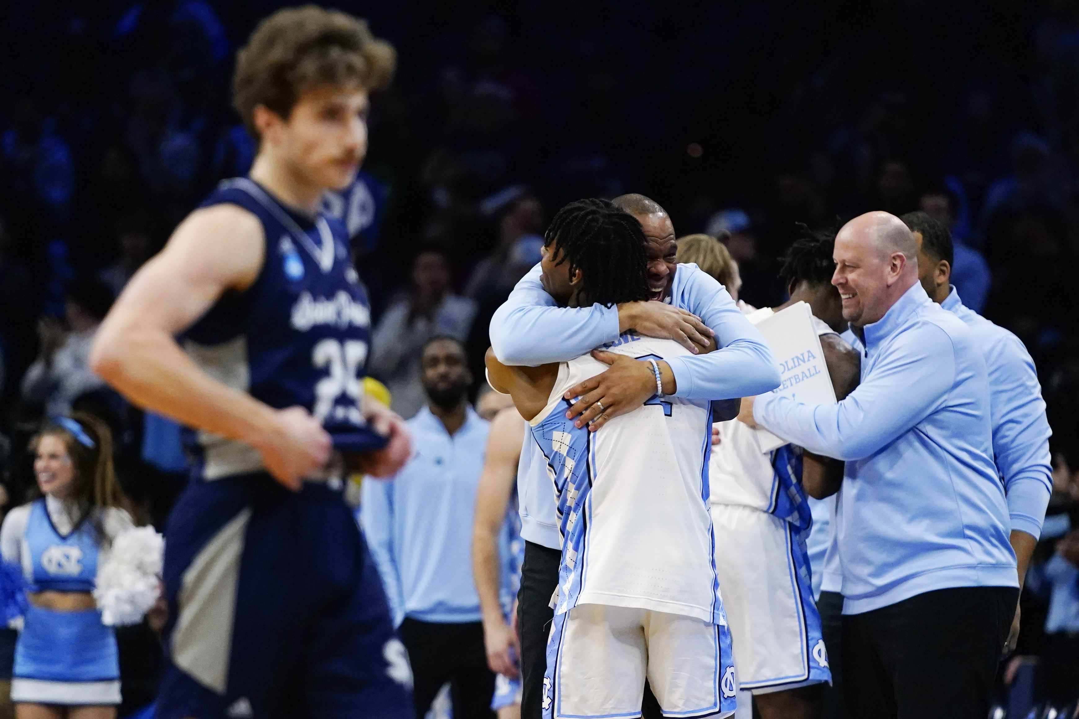 North Carolina's Hubert Davis and Caleb Love celebrate after a college basketball game against St. Peter's in the Elite 8 round of the NCAA tournament, Sunday, March 27, 2022, in Philadelphia. 